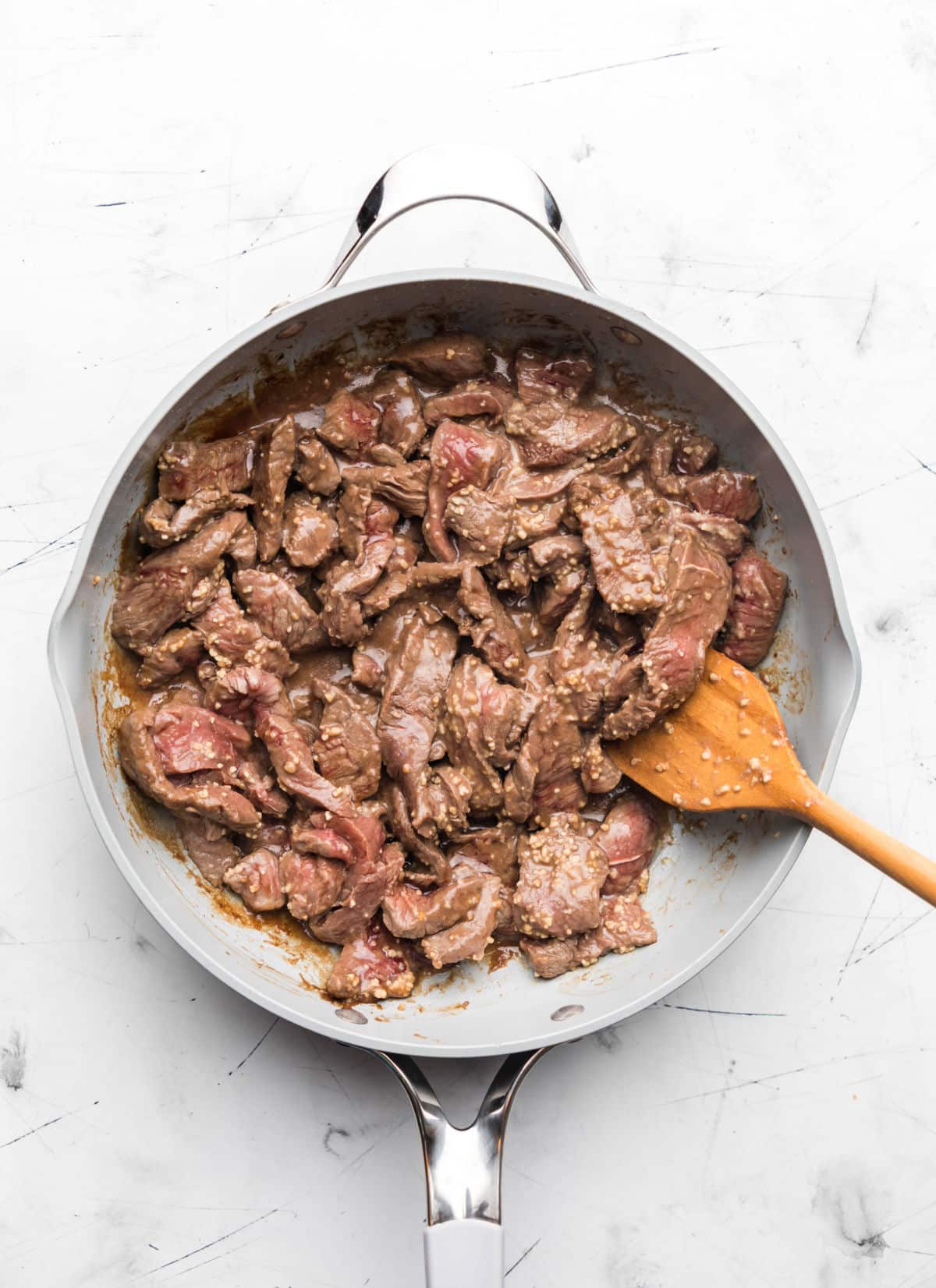 Meat cooking in a skillet without stirring.