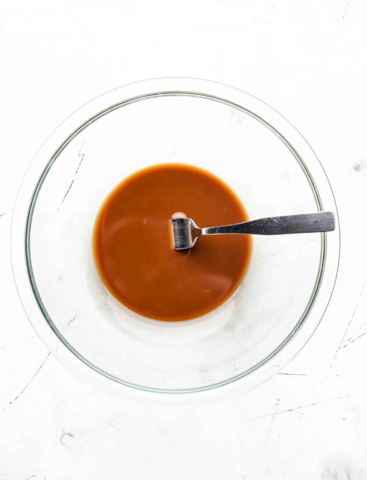 Soy sauce and cornstarch mixture in a glass mixing bowl.