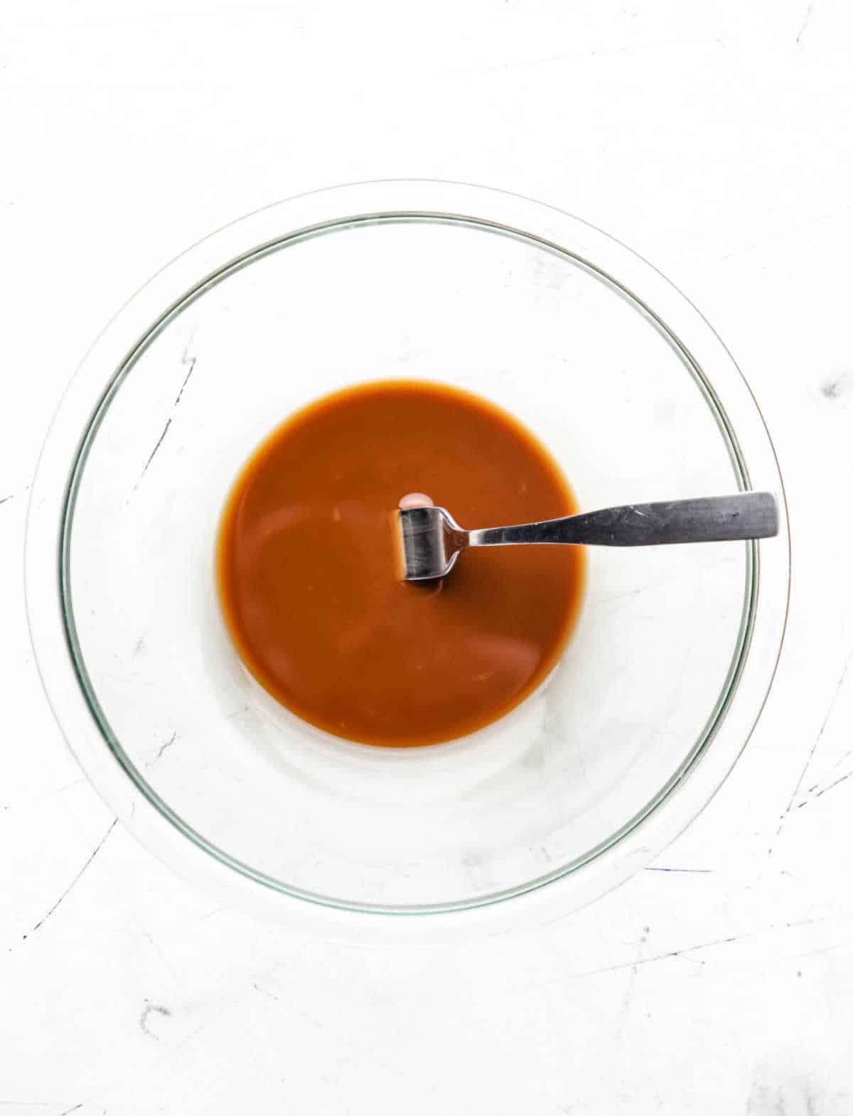 Soy sauce and cornstarch mixture in a glass mixing bowl. 