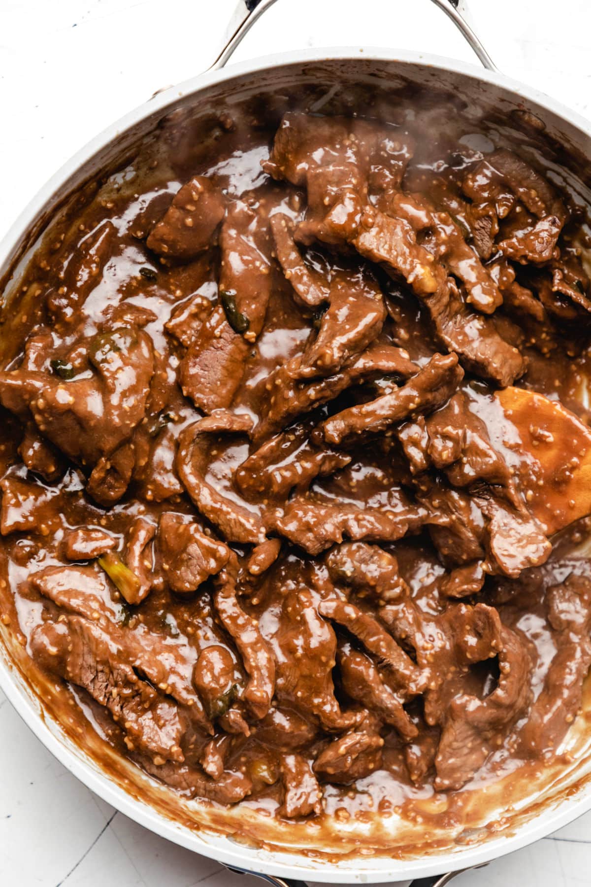 Close up photo of Mongolian beef in a saucepan.