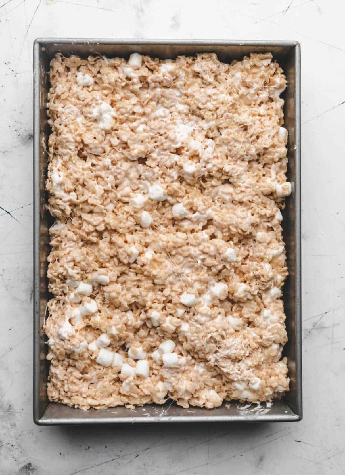 Rice krispies treat mixture in a baking pan. 