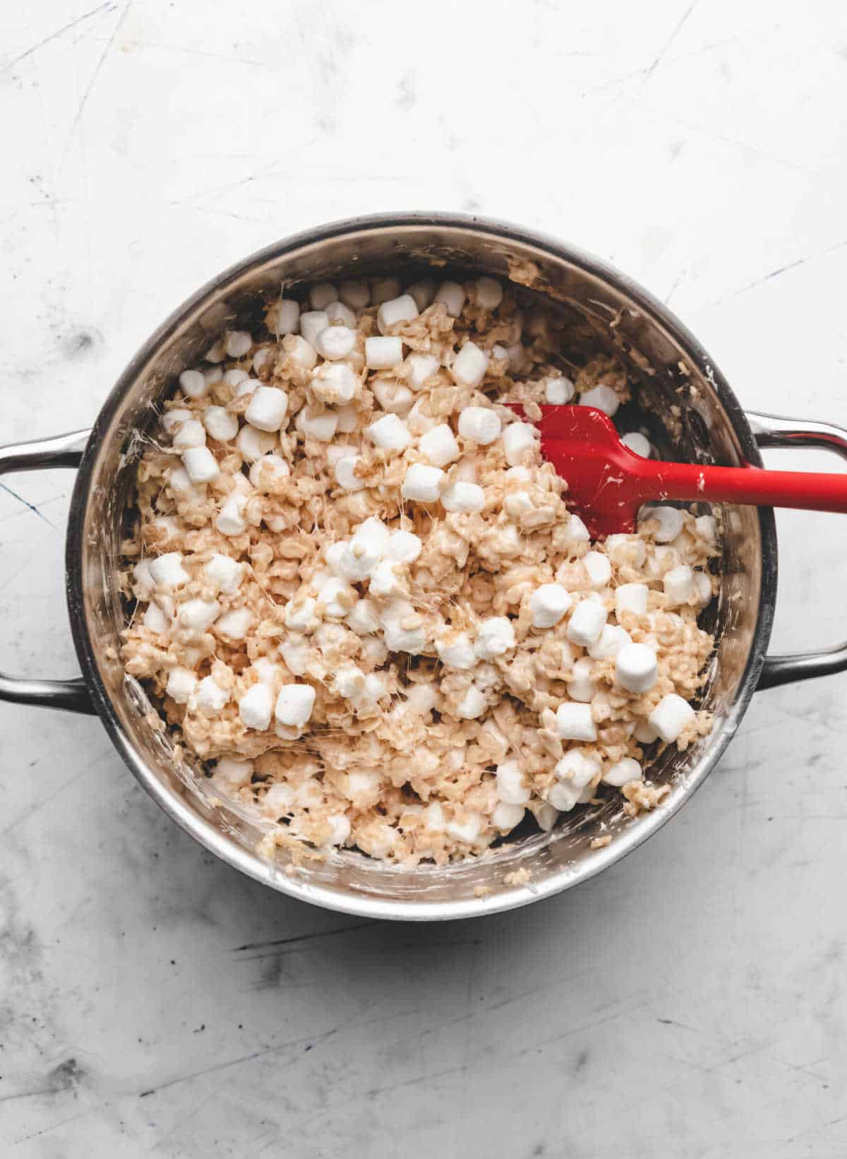 Mini marshmallows stirred into cereal treat mixture. 