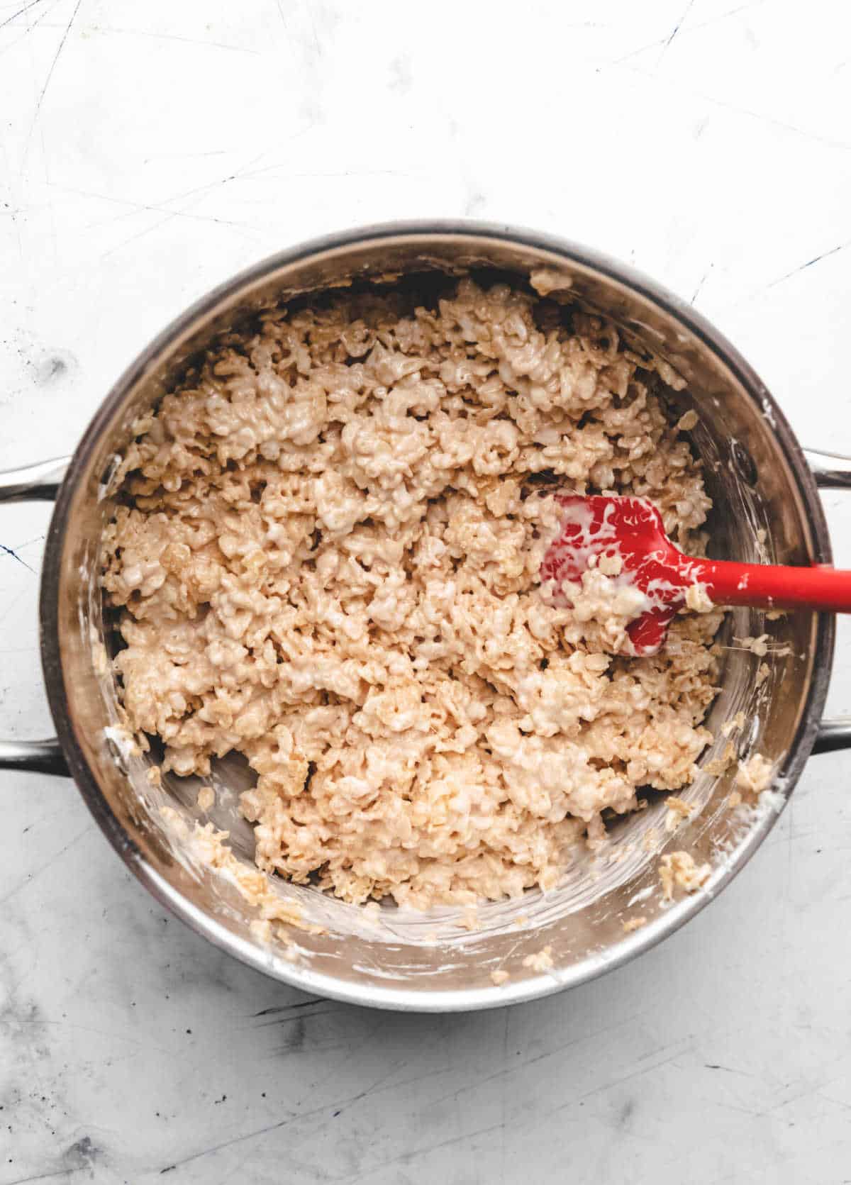 Rice krispies cereal stirred into melted marshmallow mixture. 