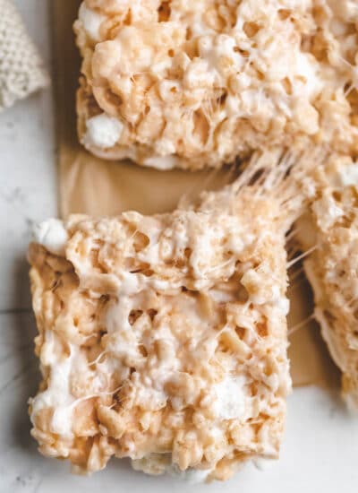 A rice krispie treat pulling away from the rest of the cereal treats.