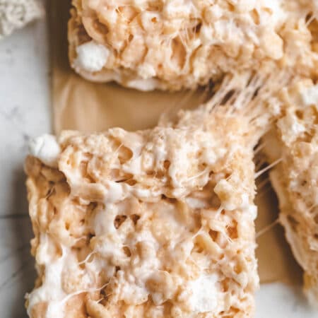 A rice krispie treat pulling away from the rest of the cereal treats.