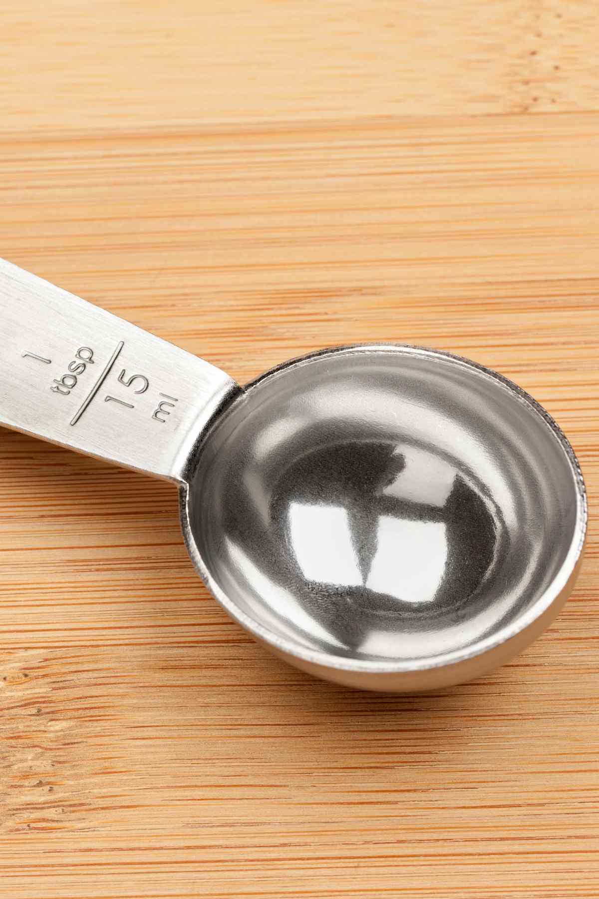 Close up photo of a tablespoon on a bamboo background. 