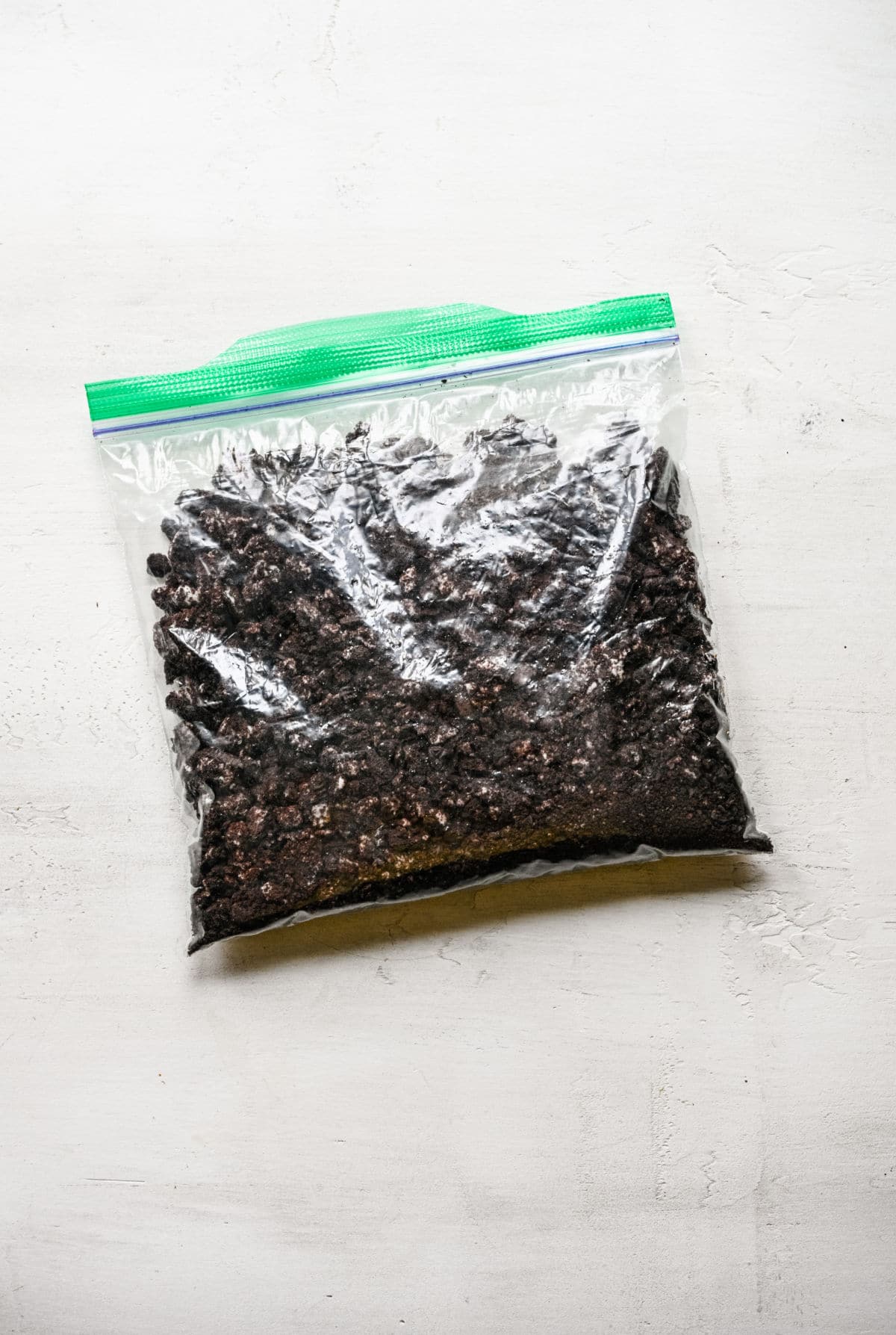 A ziploc baggie full of Oreo cookie crumbs.