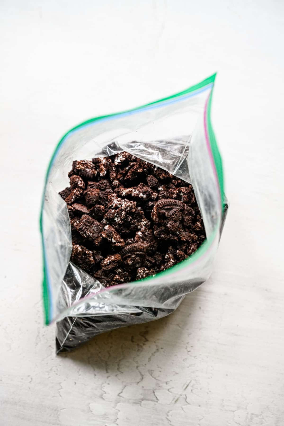 Crushed oreos in an open ziploc bag.