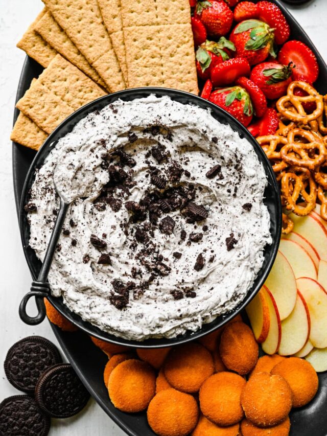 Oreo fluff in a black bowl with a spoon in it.