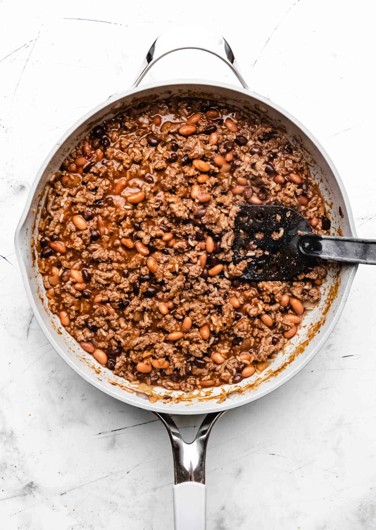 Enchilada sauce and beans stirred into ground beef mixture. 