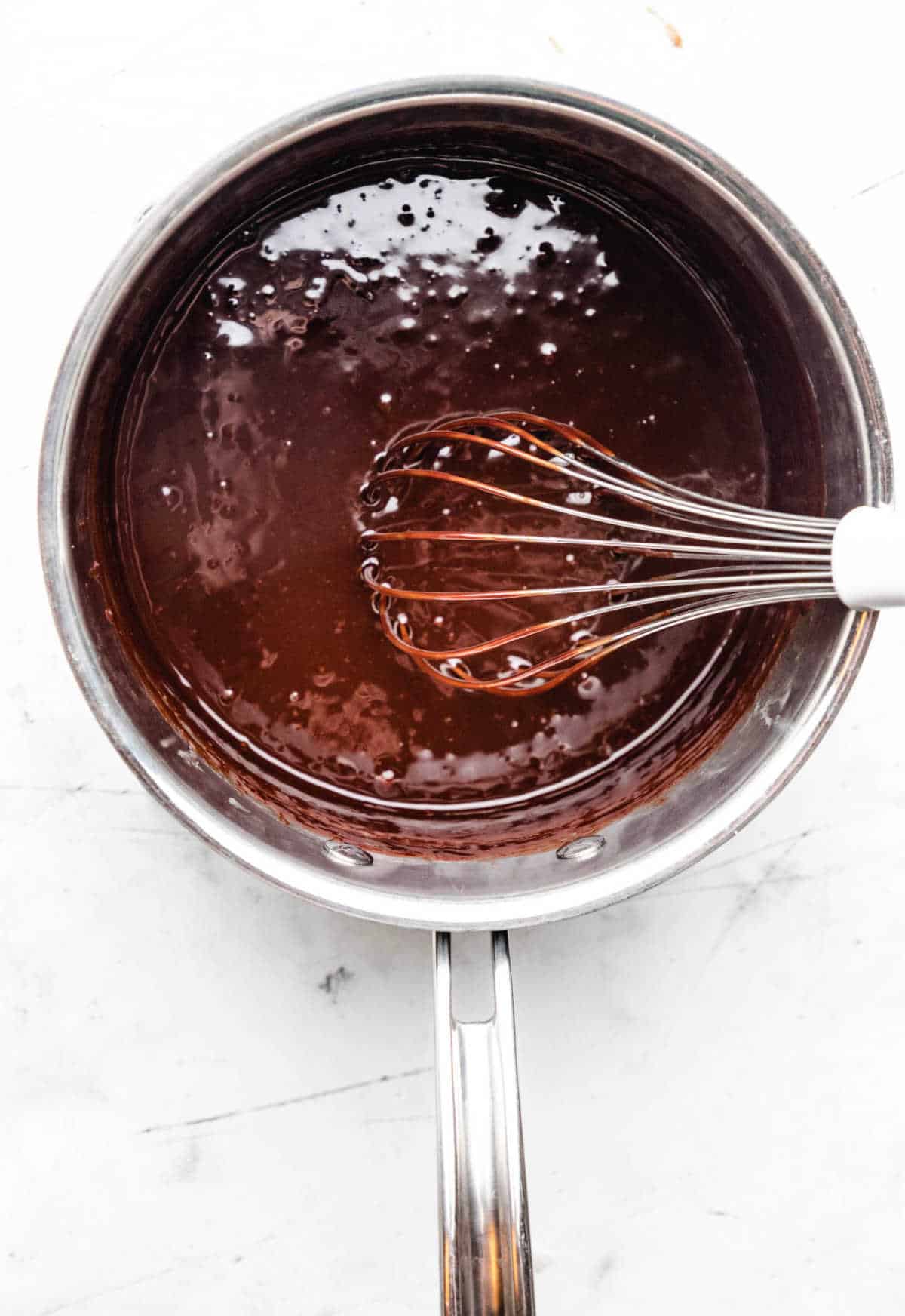 Dry ingredients whisked into melted chocolate mixture in a saucepan.