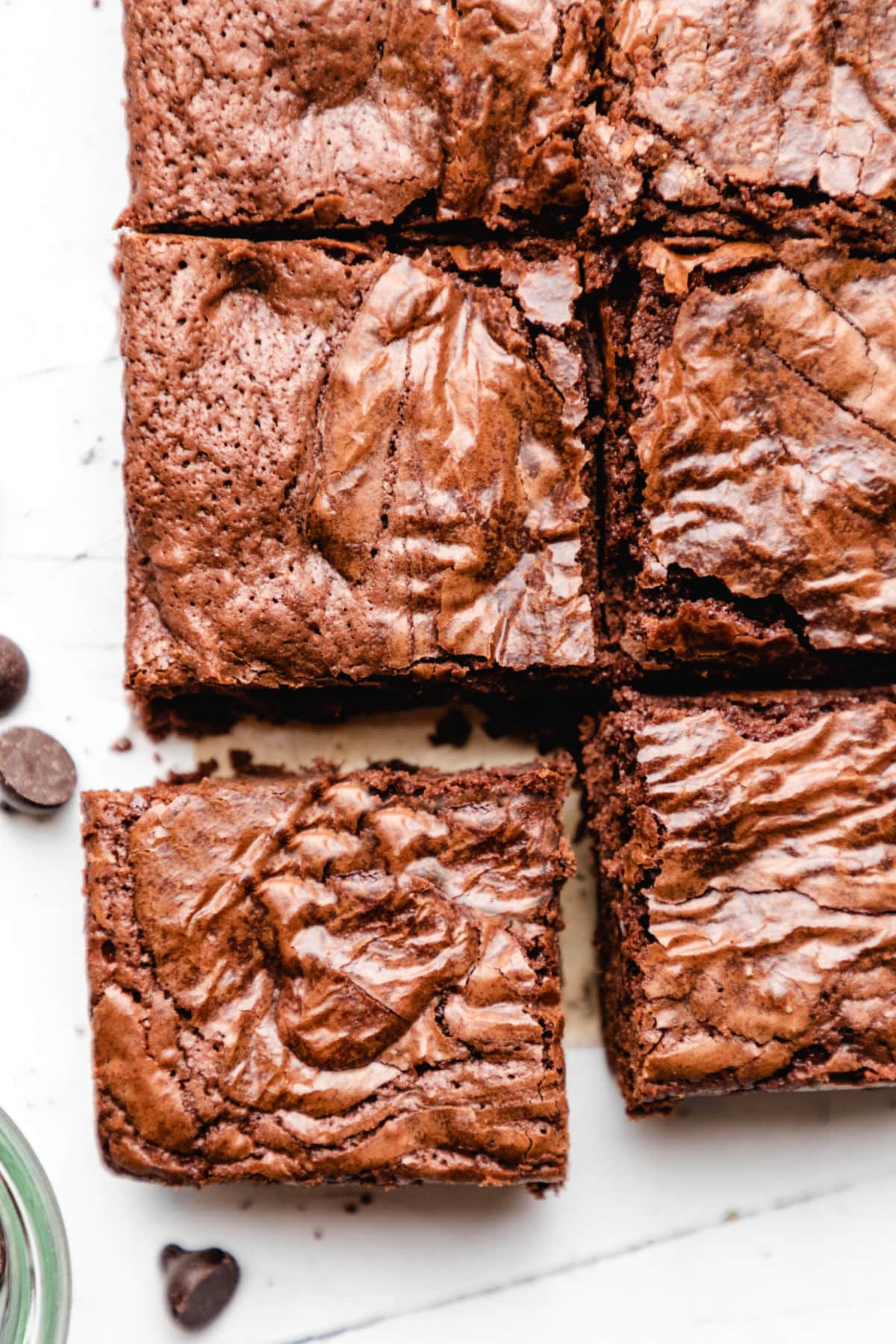 A Mexican chocolate brownie pulled away from the whole sheet of brownies. 