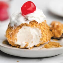 No fry fried ice cream topped with whipped cream and a cherry.