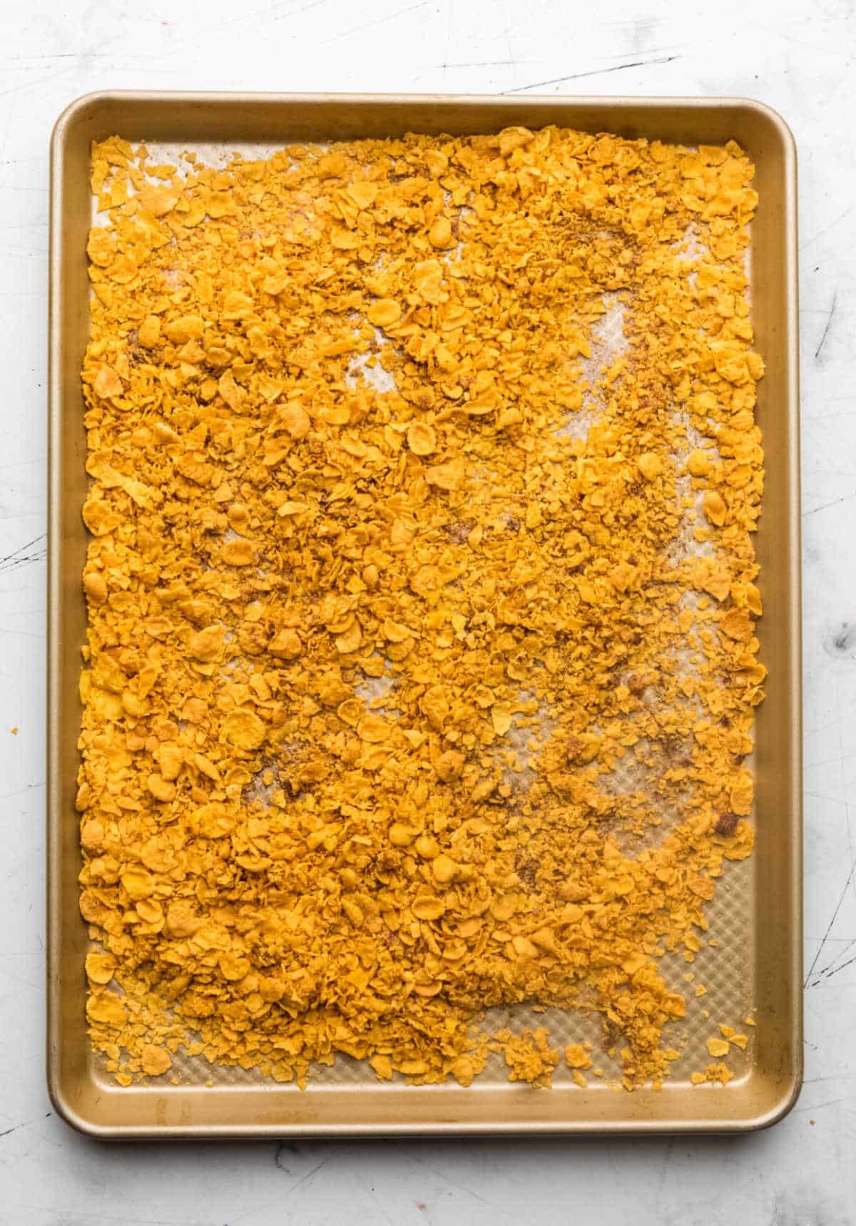 Baked cornflake mixture on a rimmed baking sheet. 