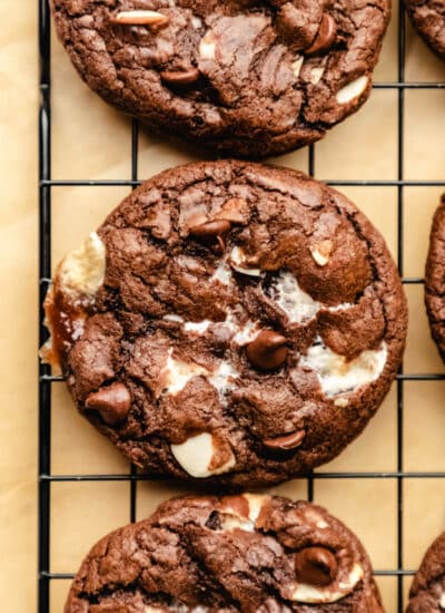 A rocky road cookie on a black cooling rack.