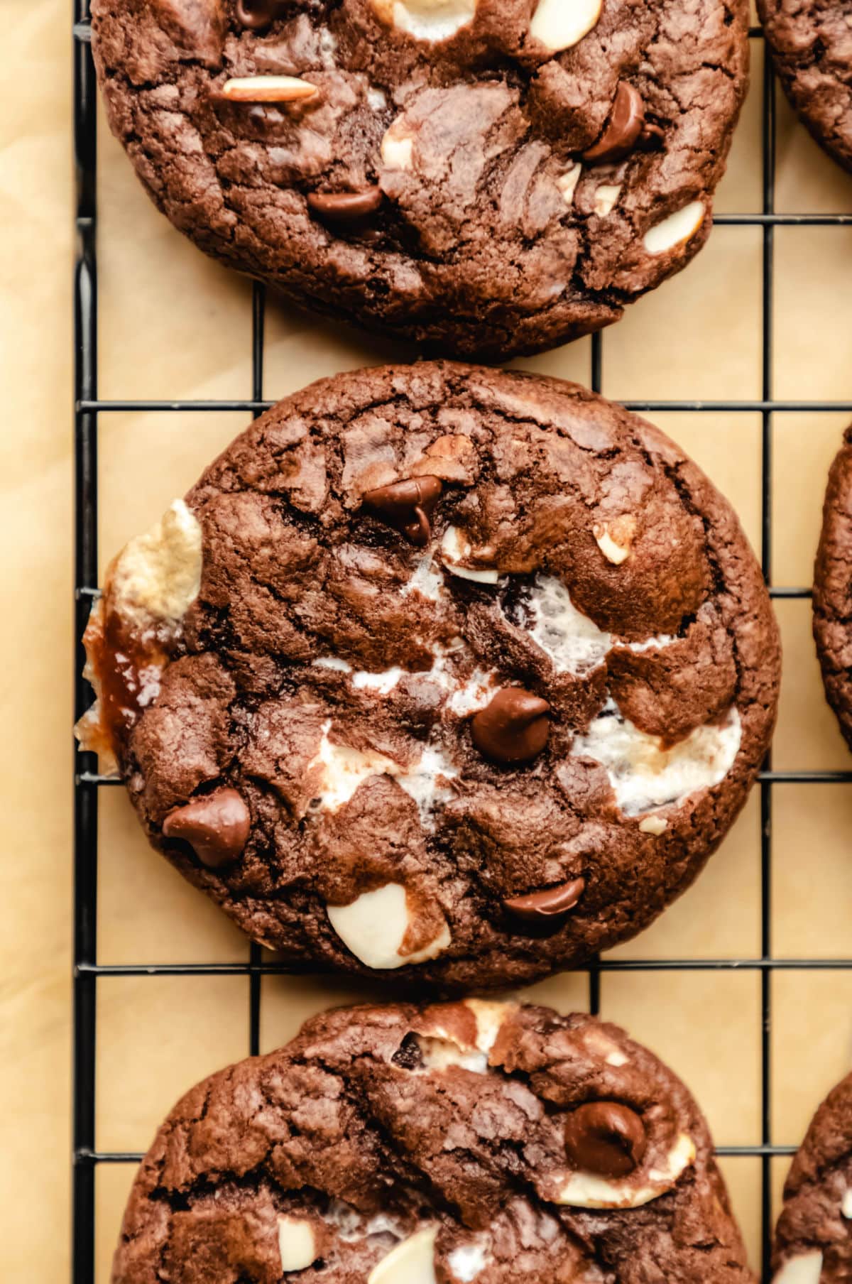 A rocky road cookie on a black cooling rack.