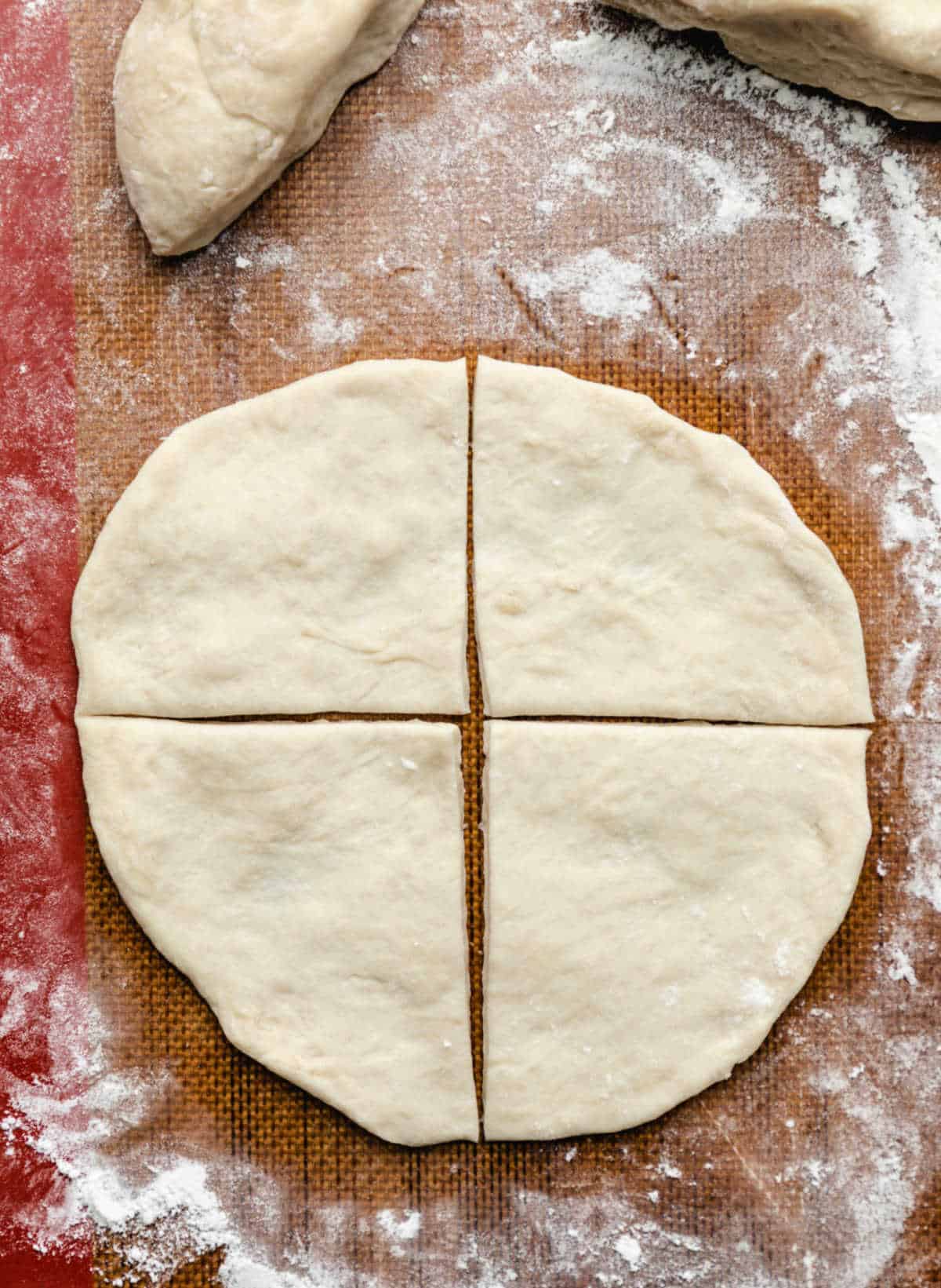 A piece of sopaipilla dough cut into 4 pieces. 