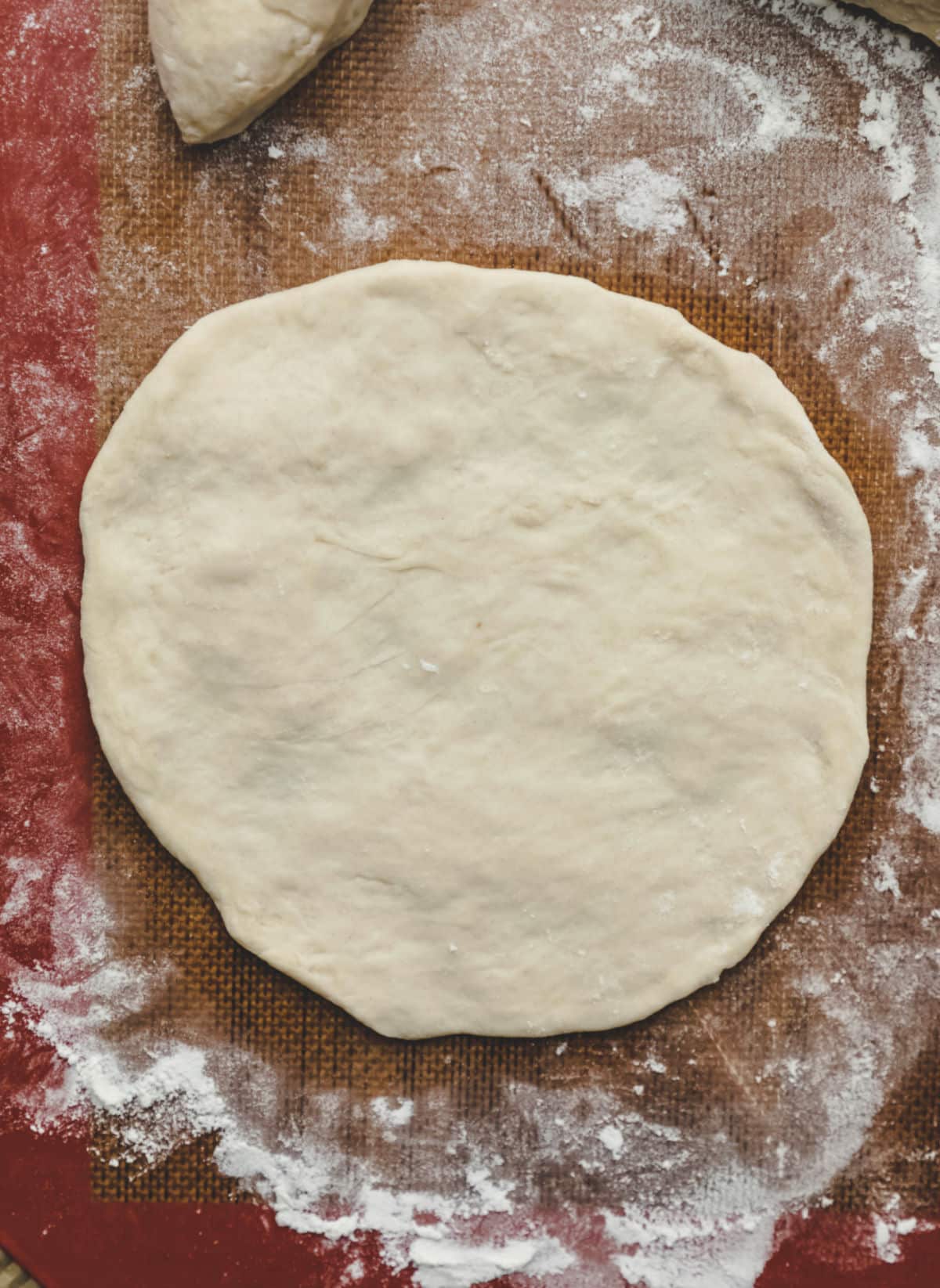 A piece of sopaipilla dough in a circle. 