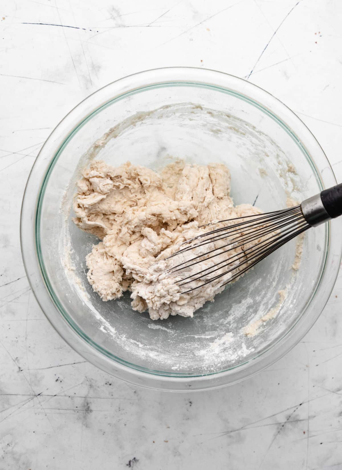 Sopaipilla dough in a glass mixing bowl. 