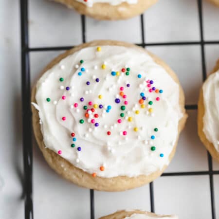 Sour cream sugar cookies on a wire cooling rack.