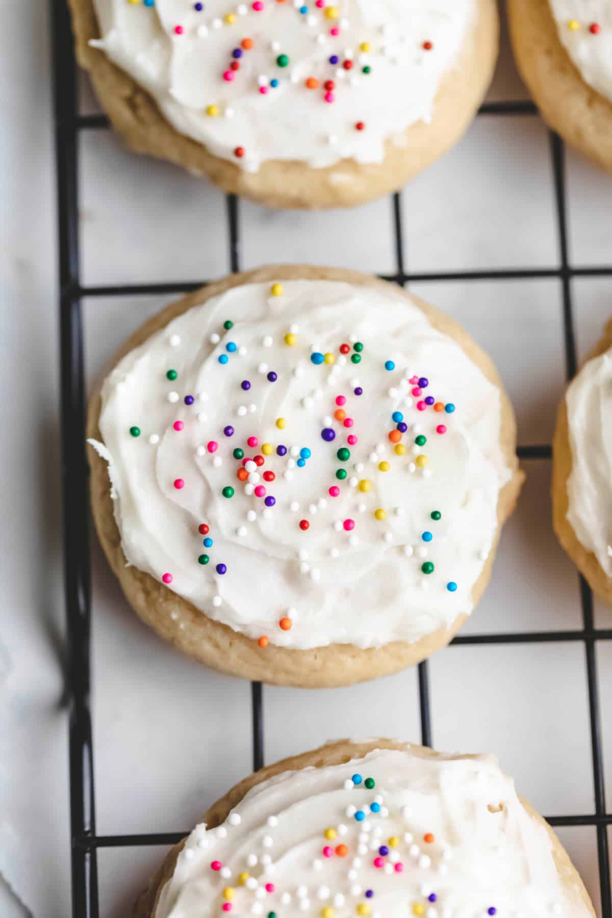 Sour cream sugar cookies on a wire cooling rack. 