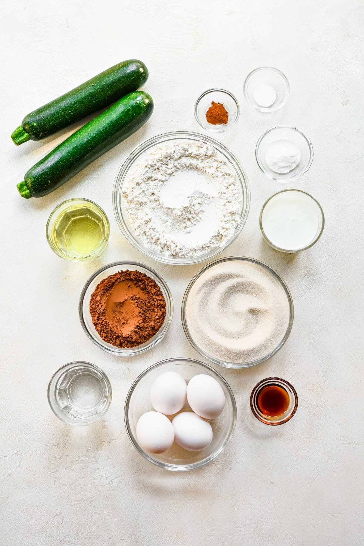 Ingredients for chocolate zucchini cake in dishes. 