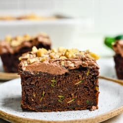 Pieces of chocolate zucchini cake on plates.
