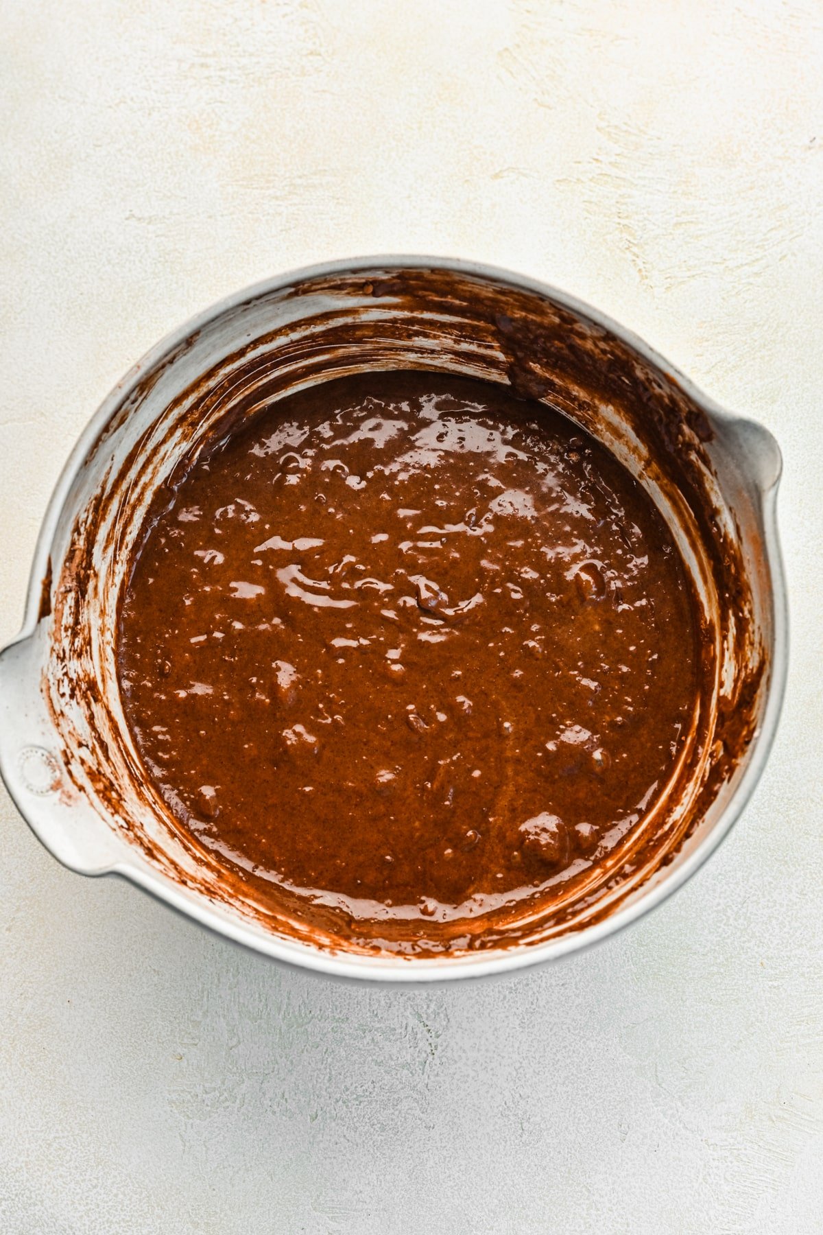 Dry ingredients whisked into wet ingredients for chocolate zucchini cake. 