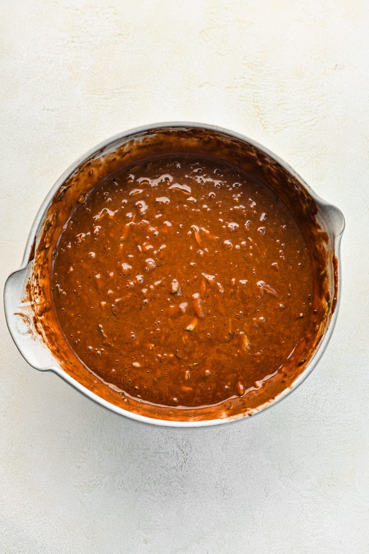 Chocolate zucchini cake batter in a mixing bowl. 