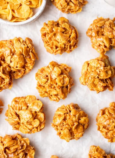 Rows of peanut butter cornflake cookies on parchment paper.