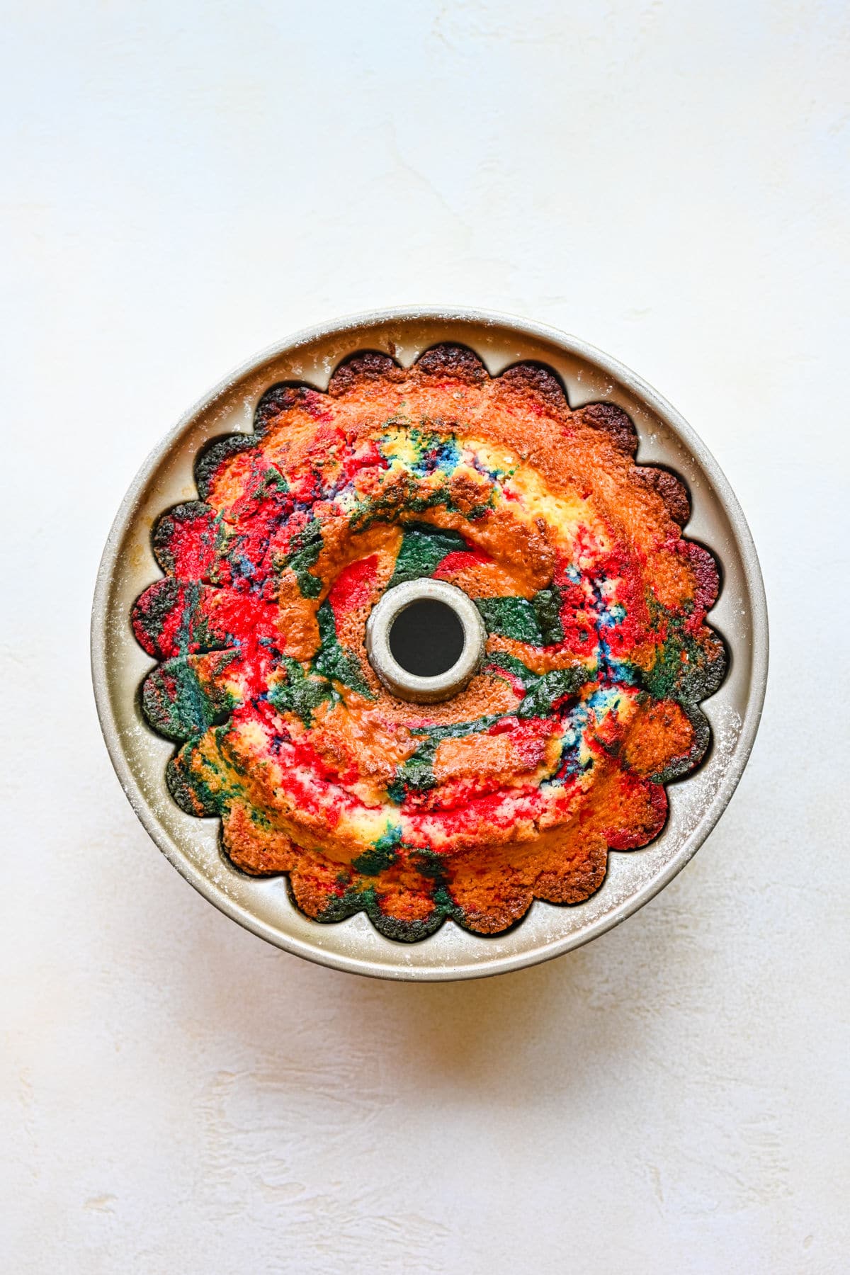 Baked red white and blue bundt cake in a pan.