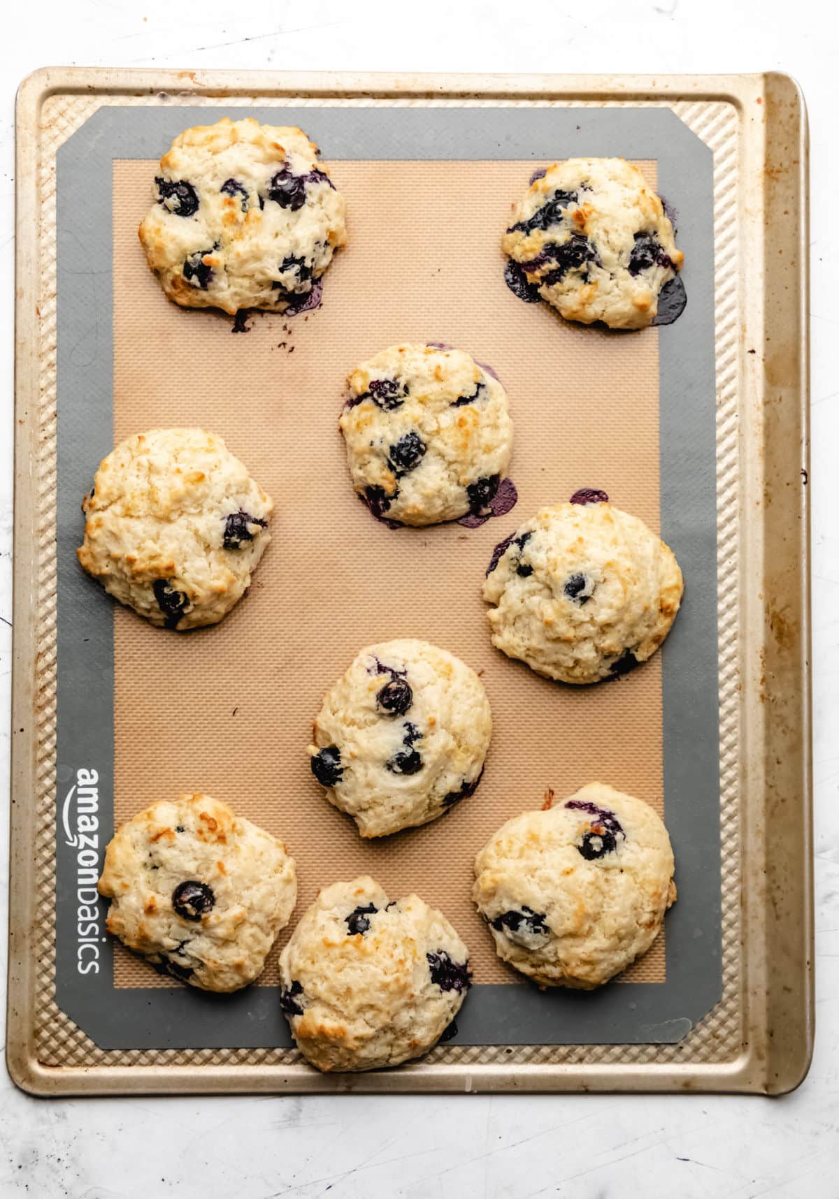 Baked blueberry biscuits on a baking sheet. 