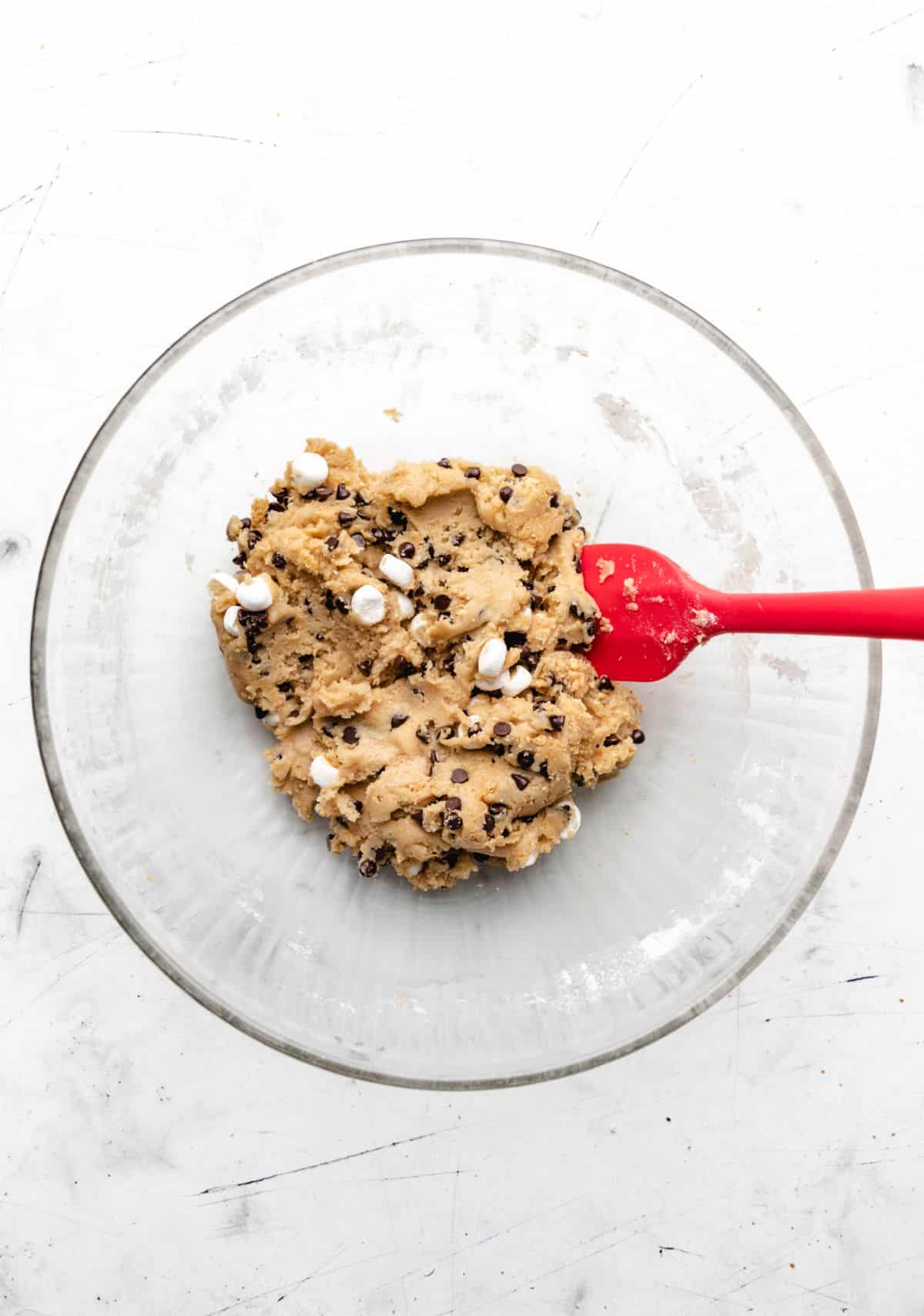 S'mores cookie dough in a glass mixing bowl. 