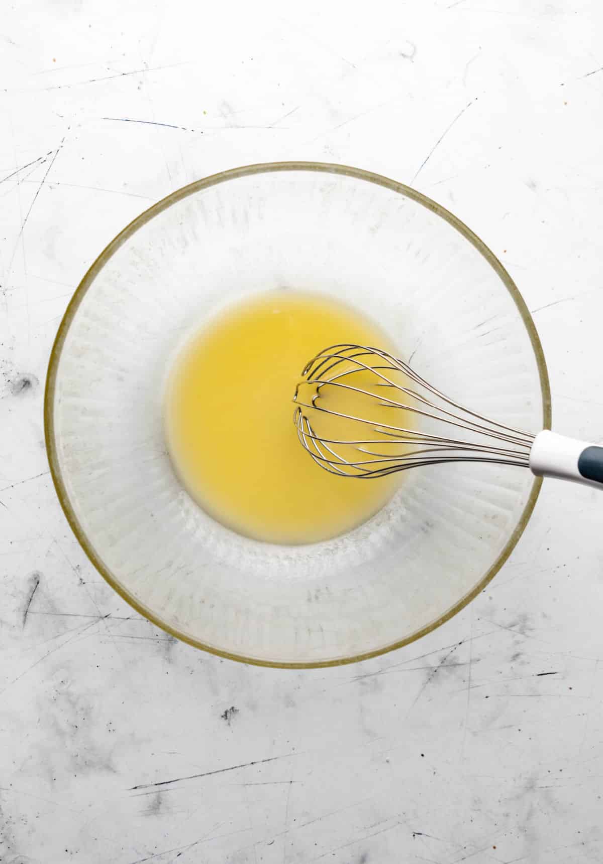 Melted butter in a glass mixing bowl. 