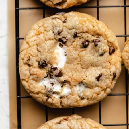 A row of s'mores cookies on a wire cooling rack.