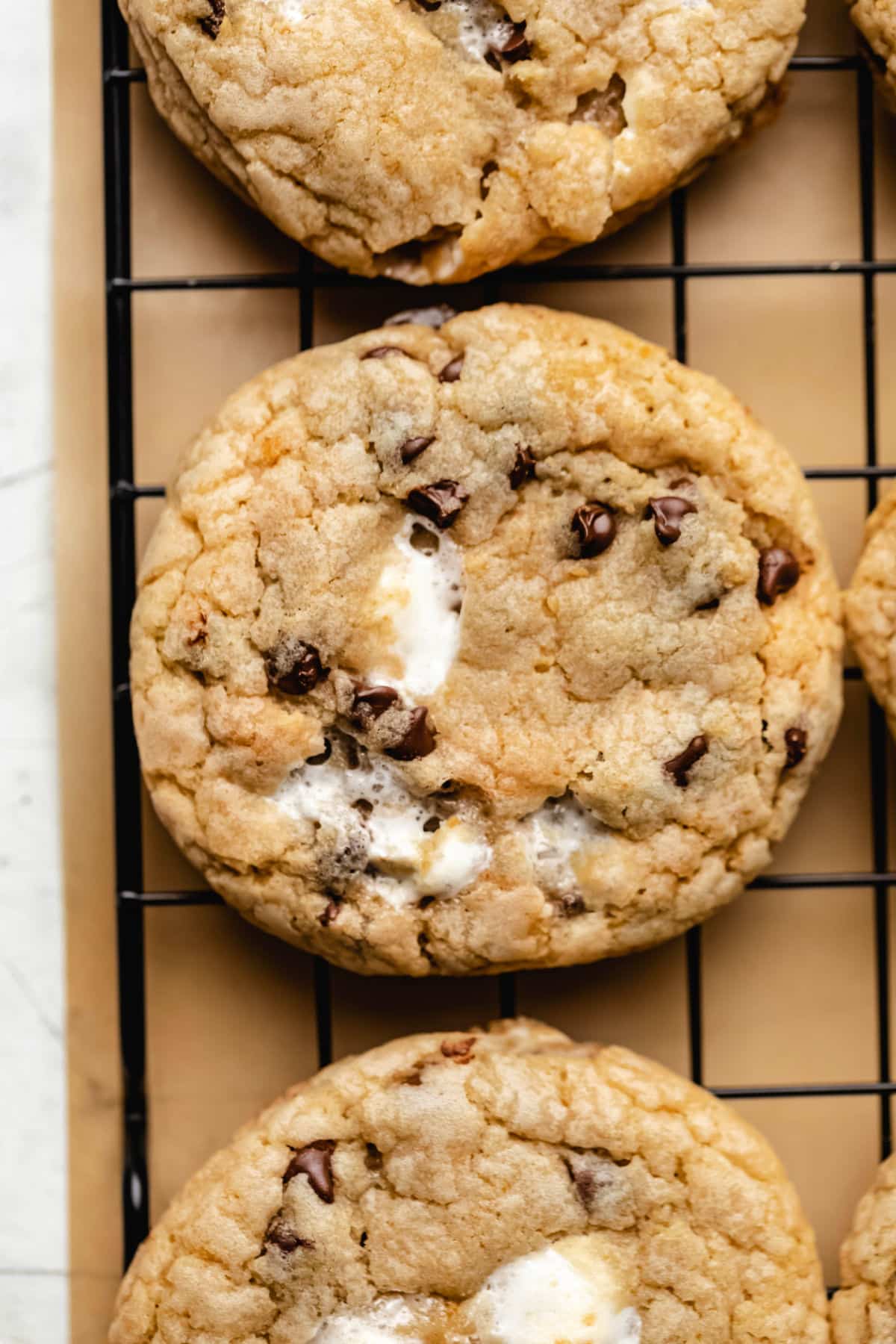 S'mores cookies on a black wire cooling rack.