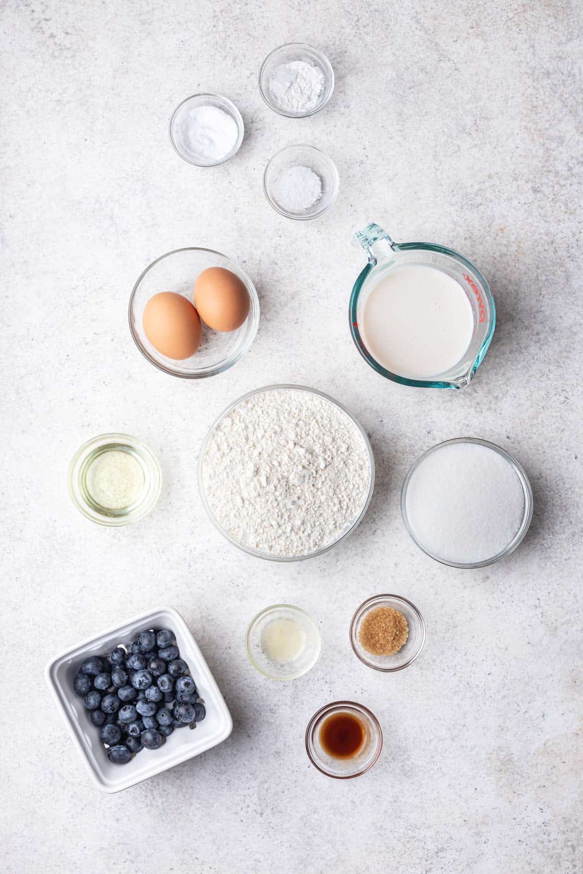 Ingredients for mini blueberry muffins in dishes.
