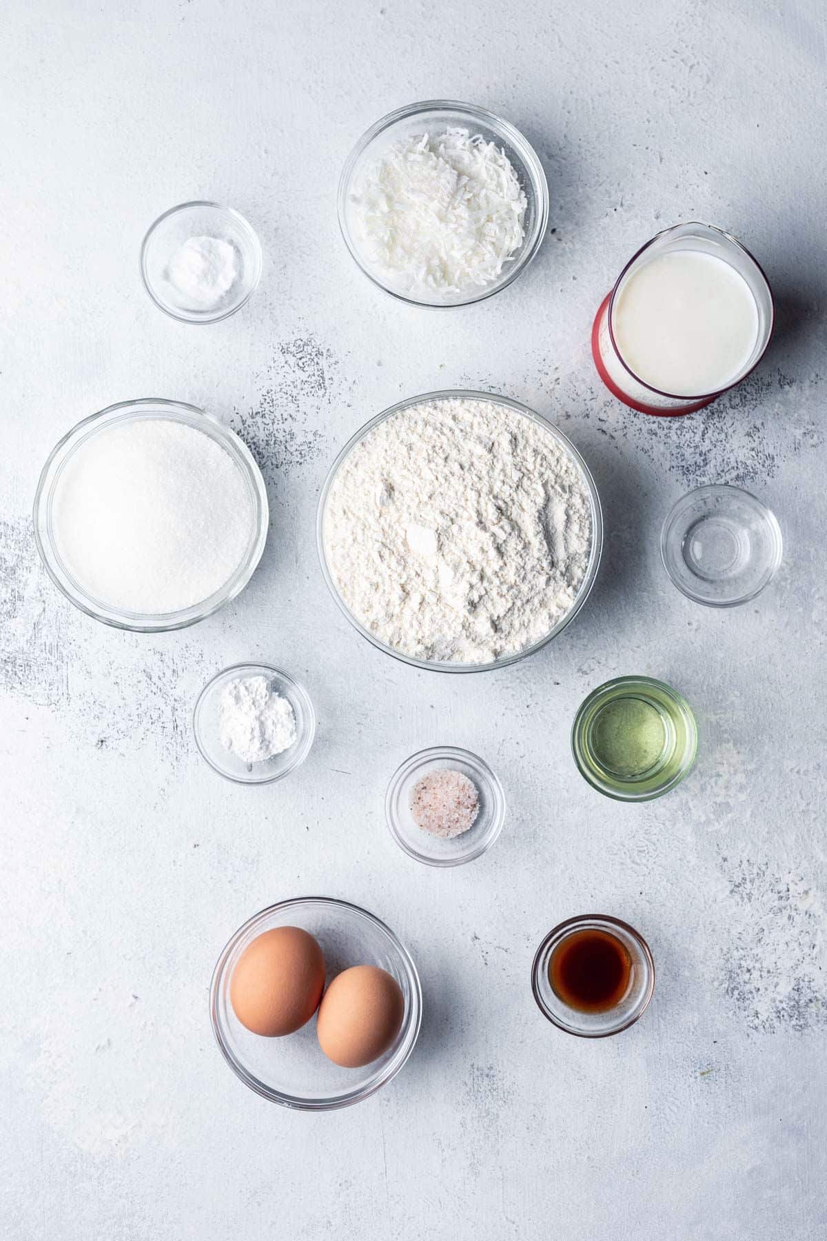 Ingredients for coconut muffins in dishes.