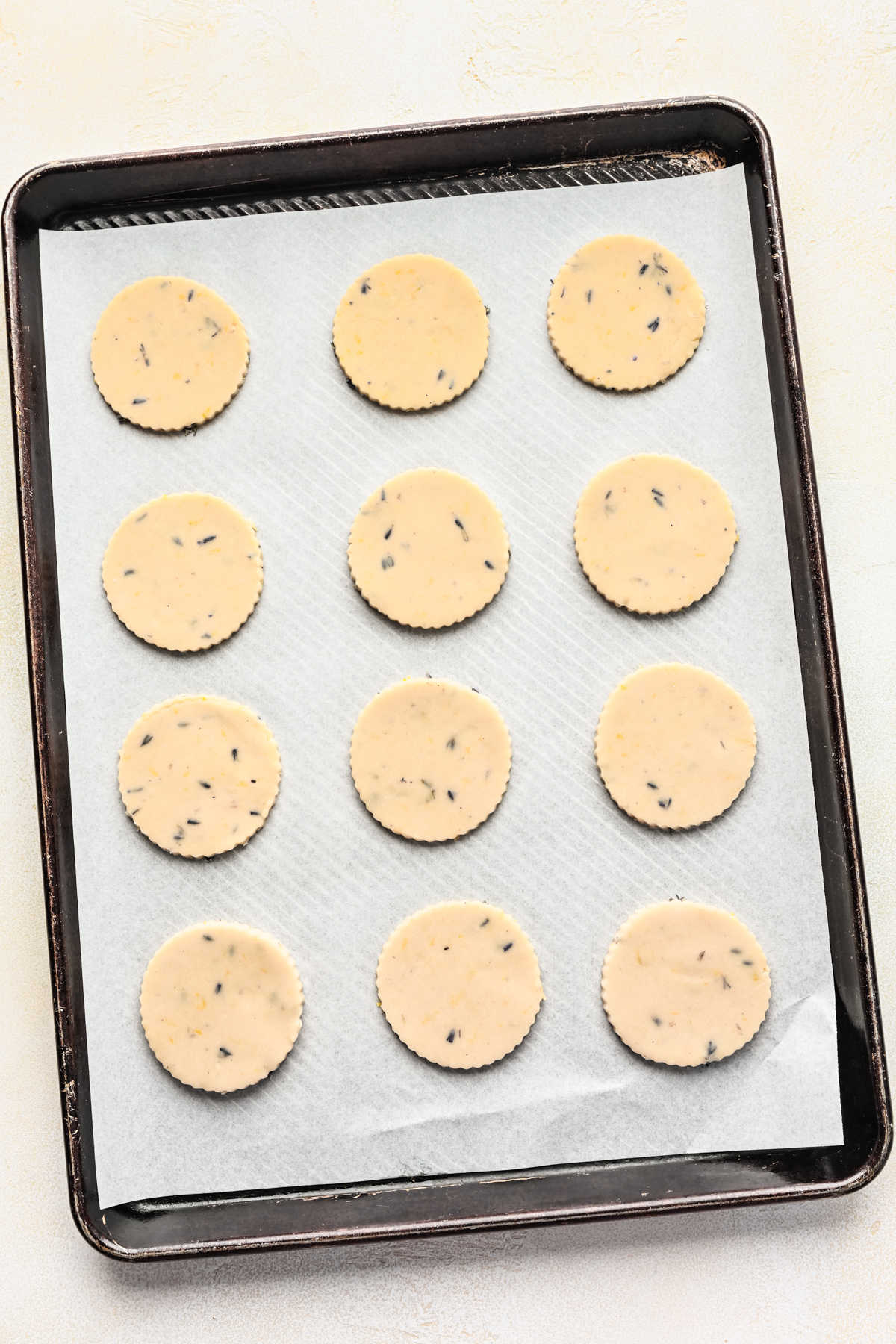 Unbaked lavender cookie dough onto a parchment lined baking sheet.
