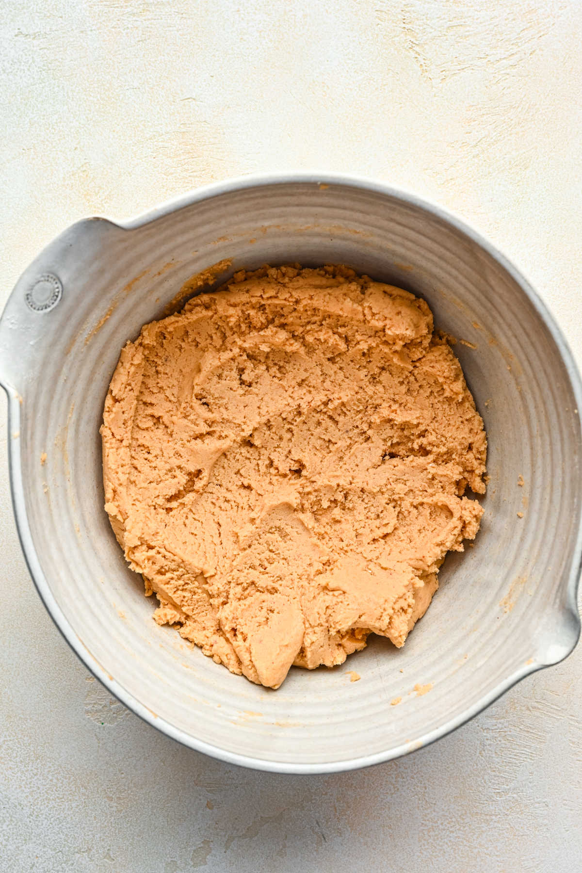 Peanut butter cookie dough in a mixing bowl. 