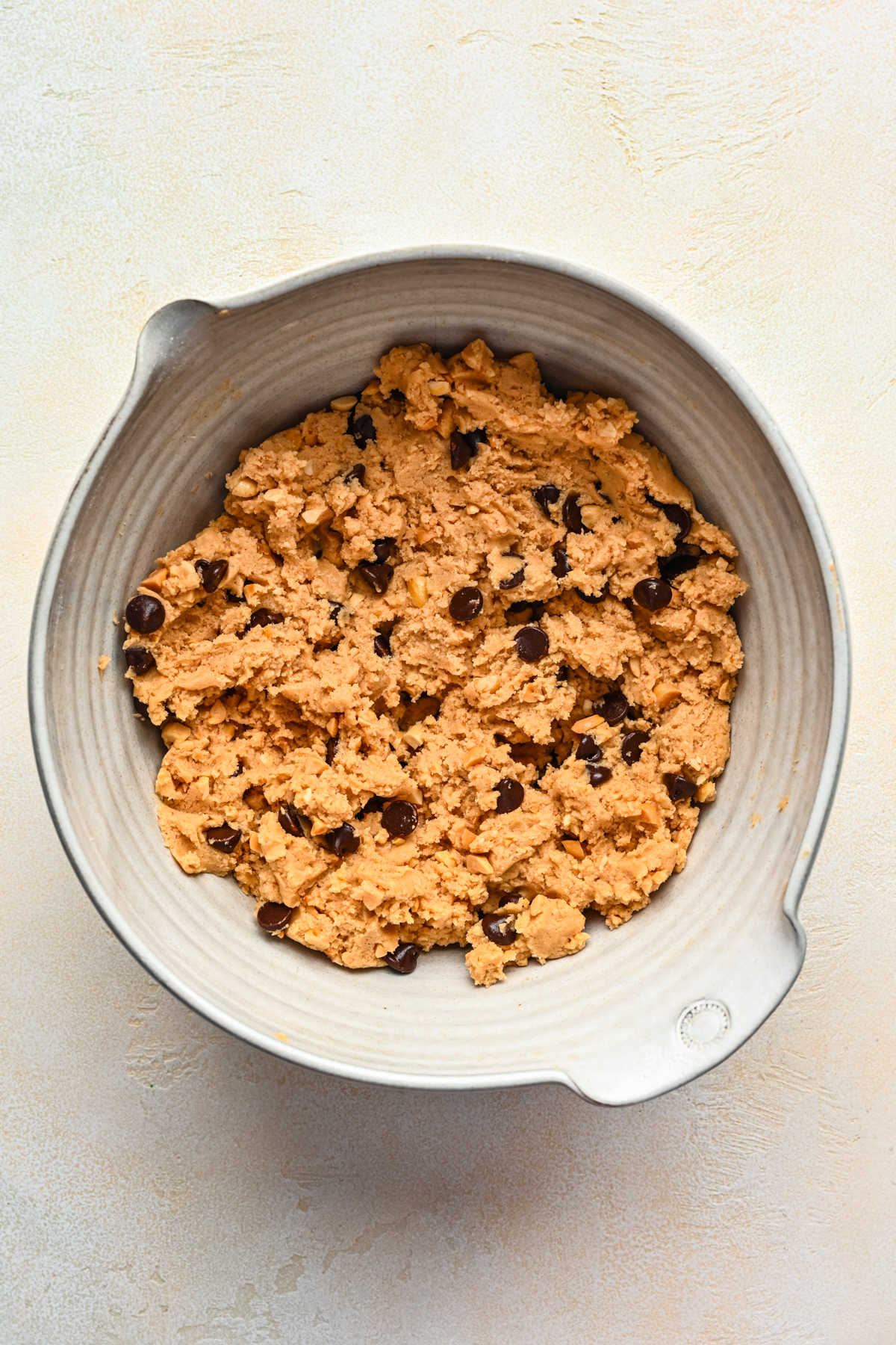 Peanut butter chocolate chip cookie dough in a mixing bowl. 