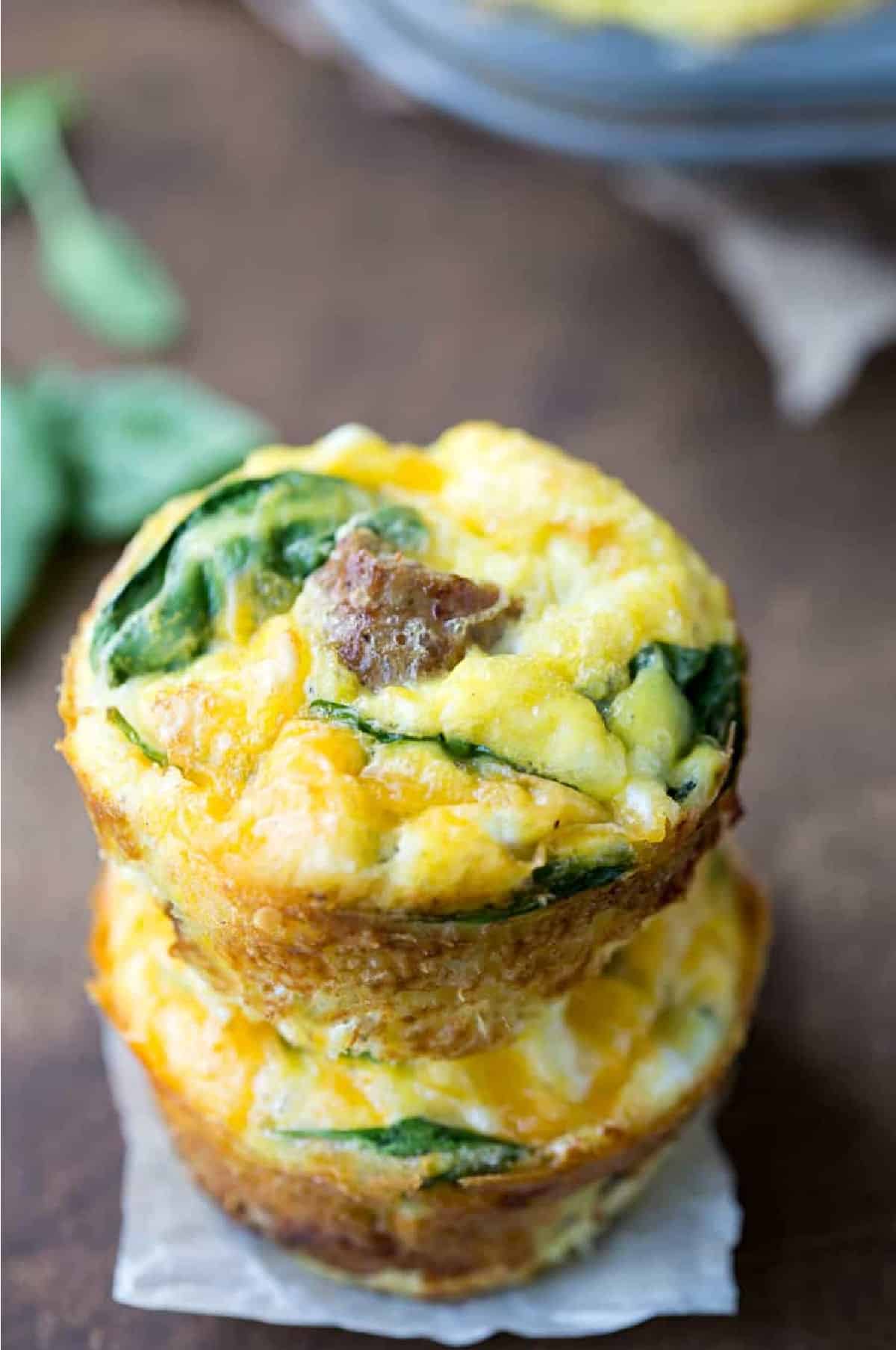 Two sausage egg muffins stacked on top of each other. 