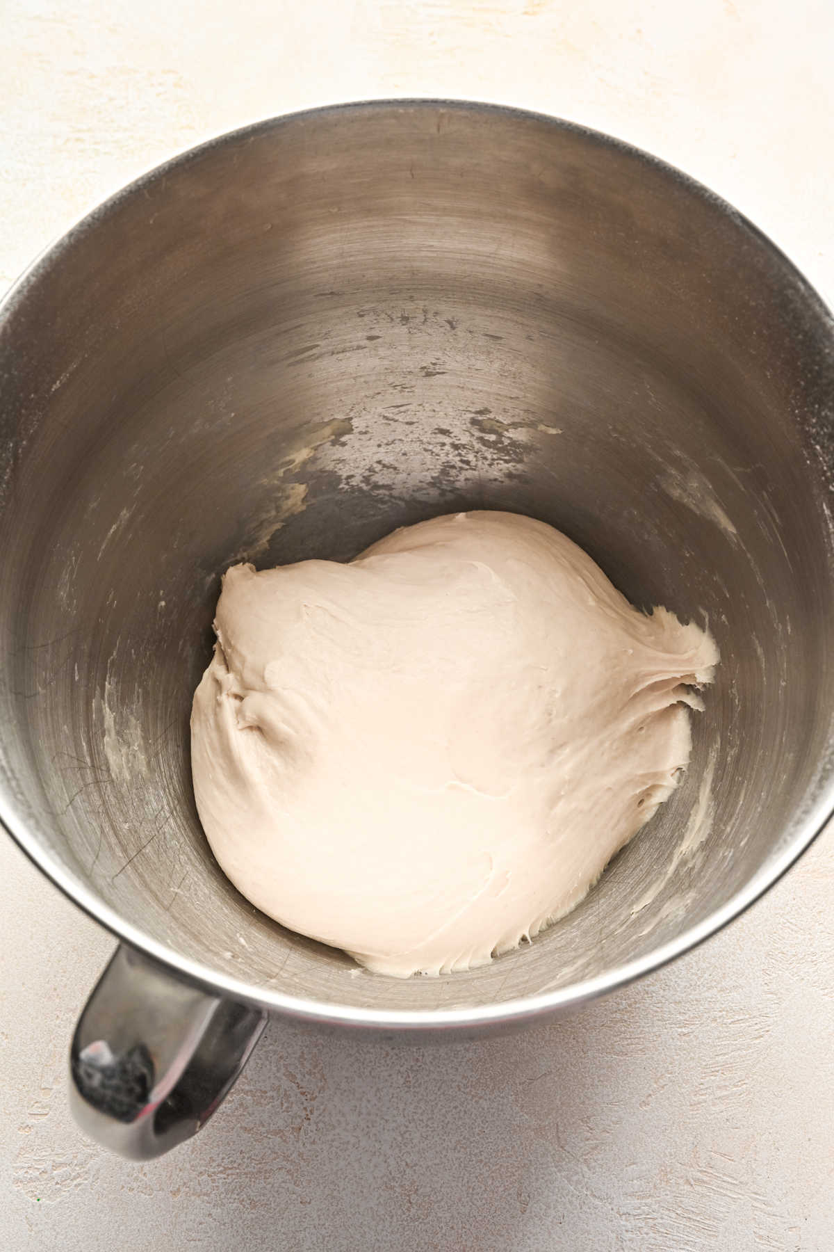 Breadstick dough in a silver mixing bowl. 