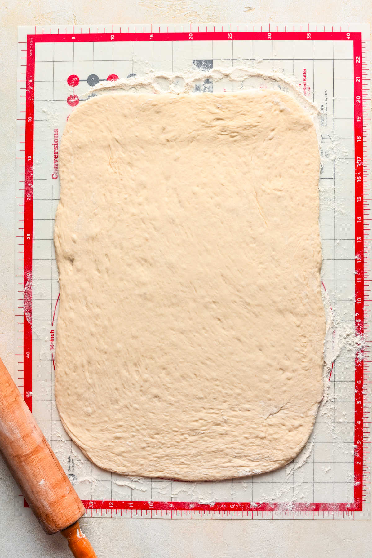 Rolled out breadstick dough on a silicone baking mat.