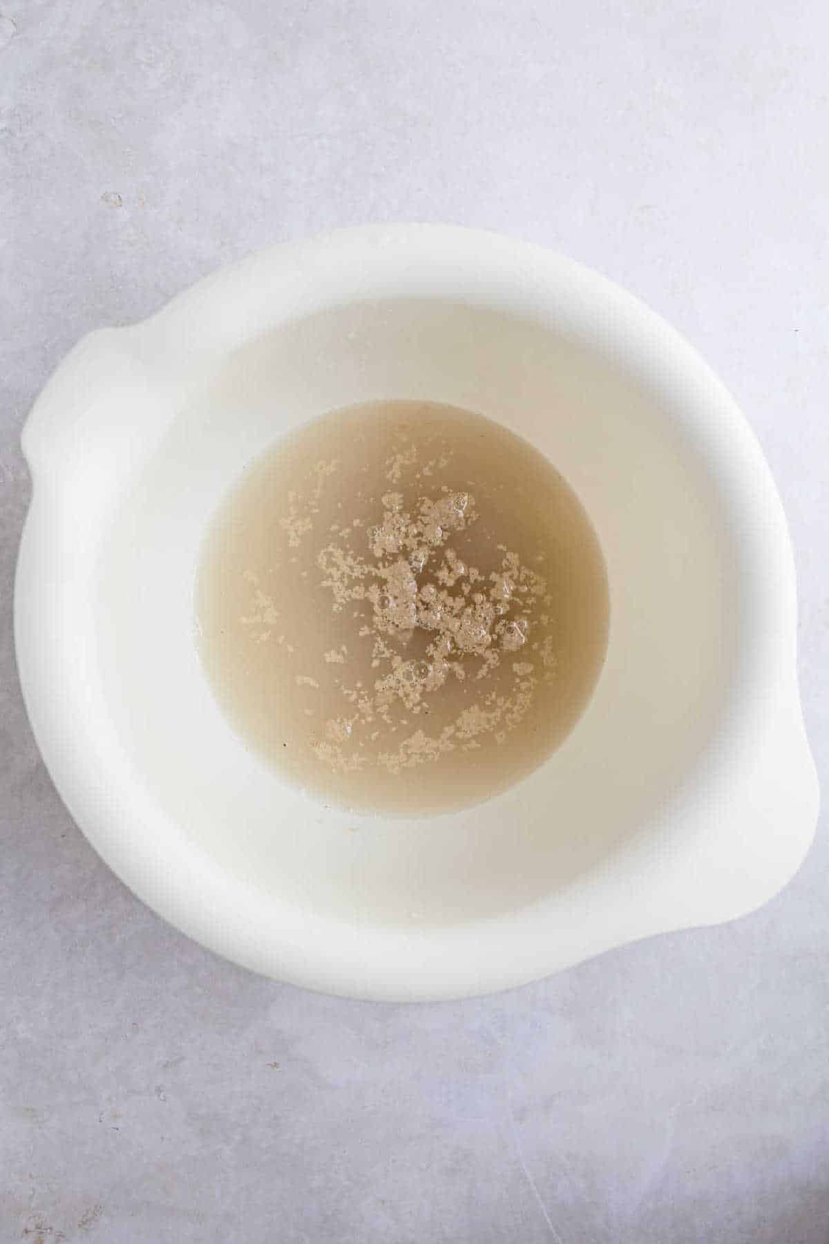 Yeast sugar and water in a mixing bowl.