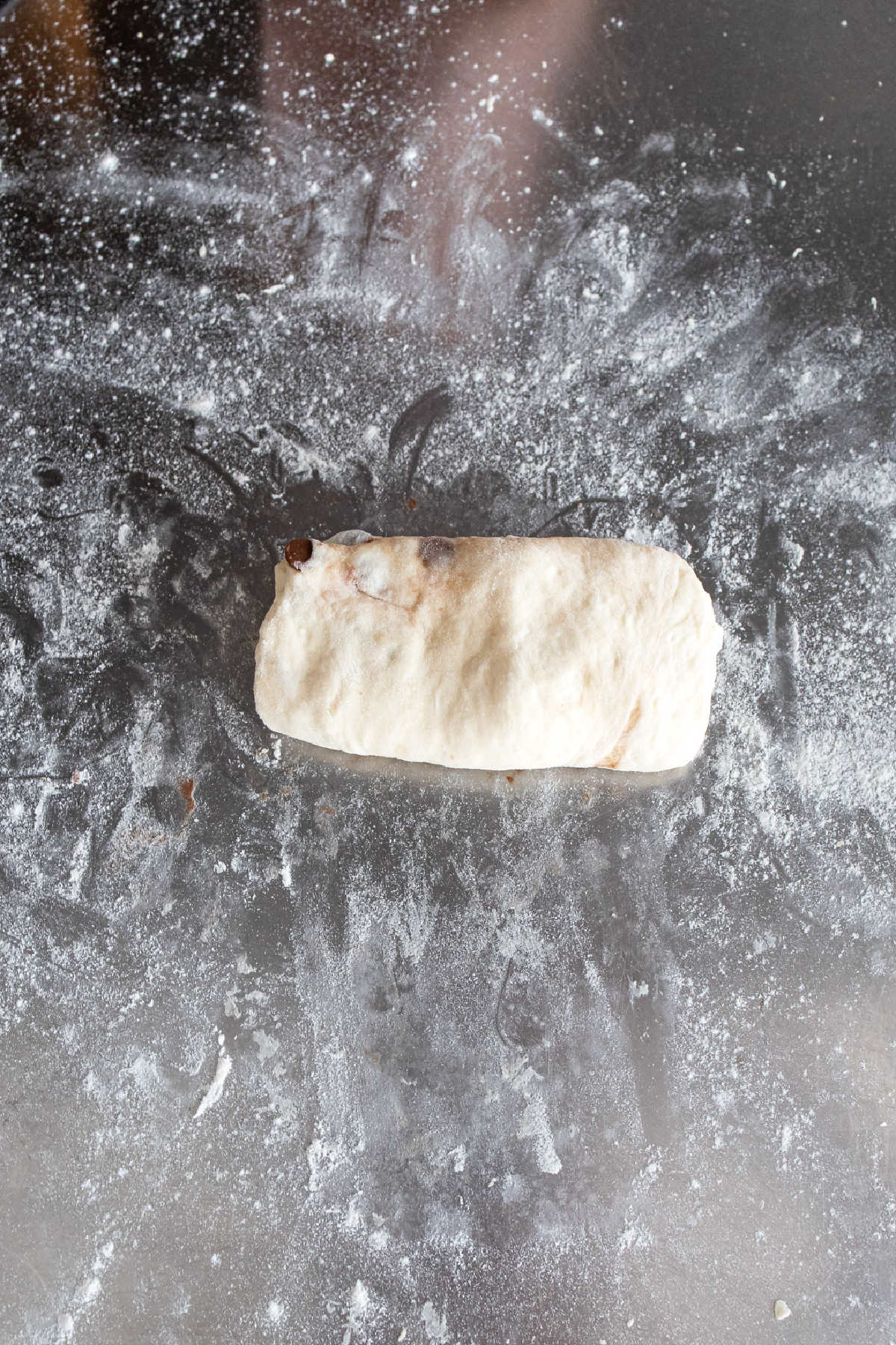 Chocolate chip baguette dough folded into thirds. 