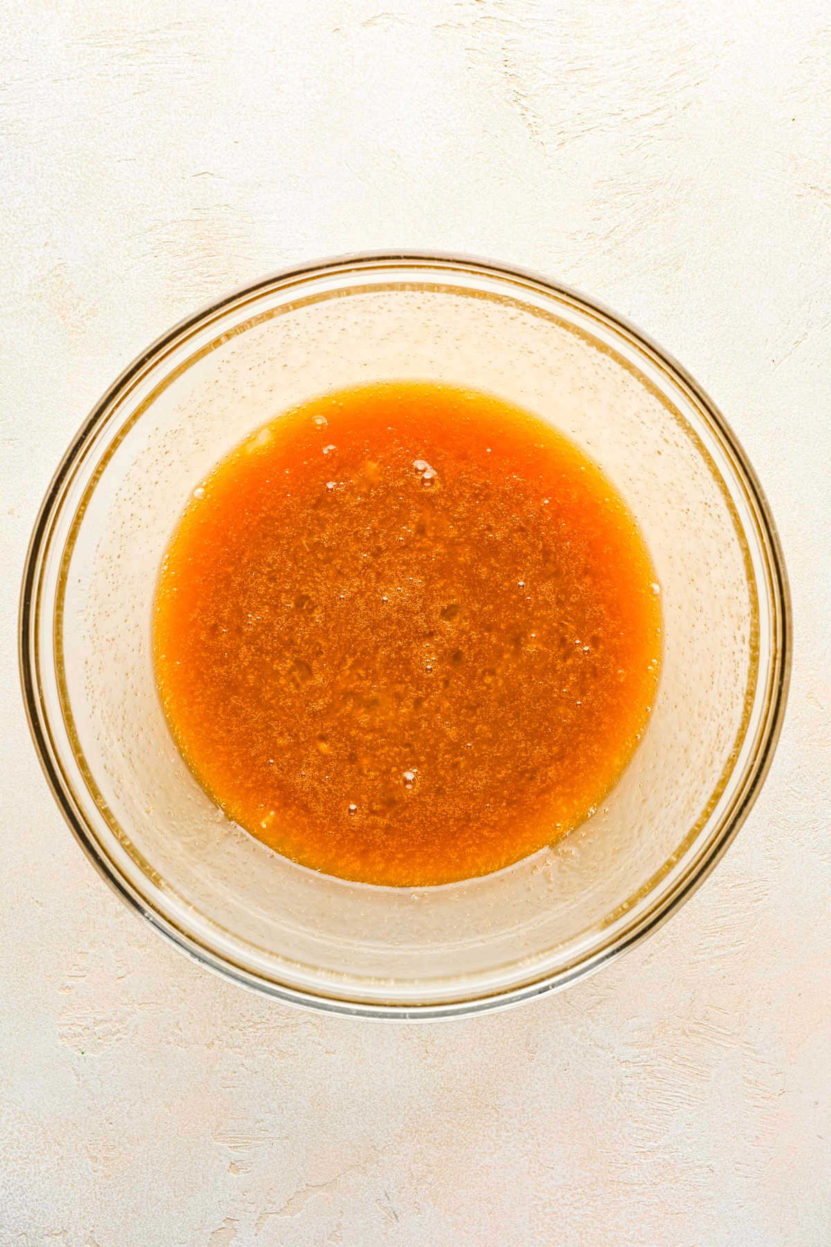 Brown sugar and corn syrup with egg mixture in a mixing bowl.