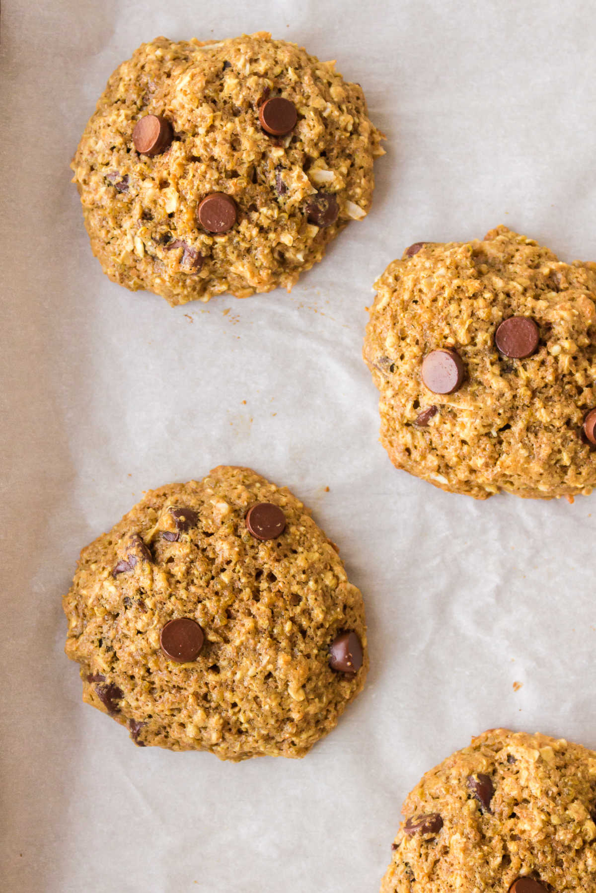 Baked quinoa cookies on a piece of parchment paper. 