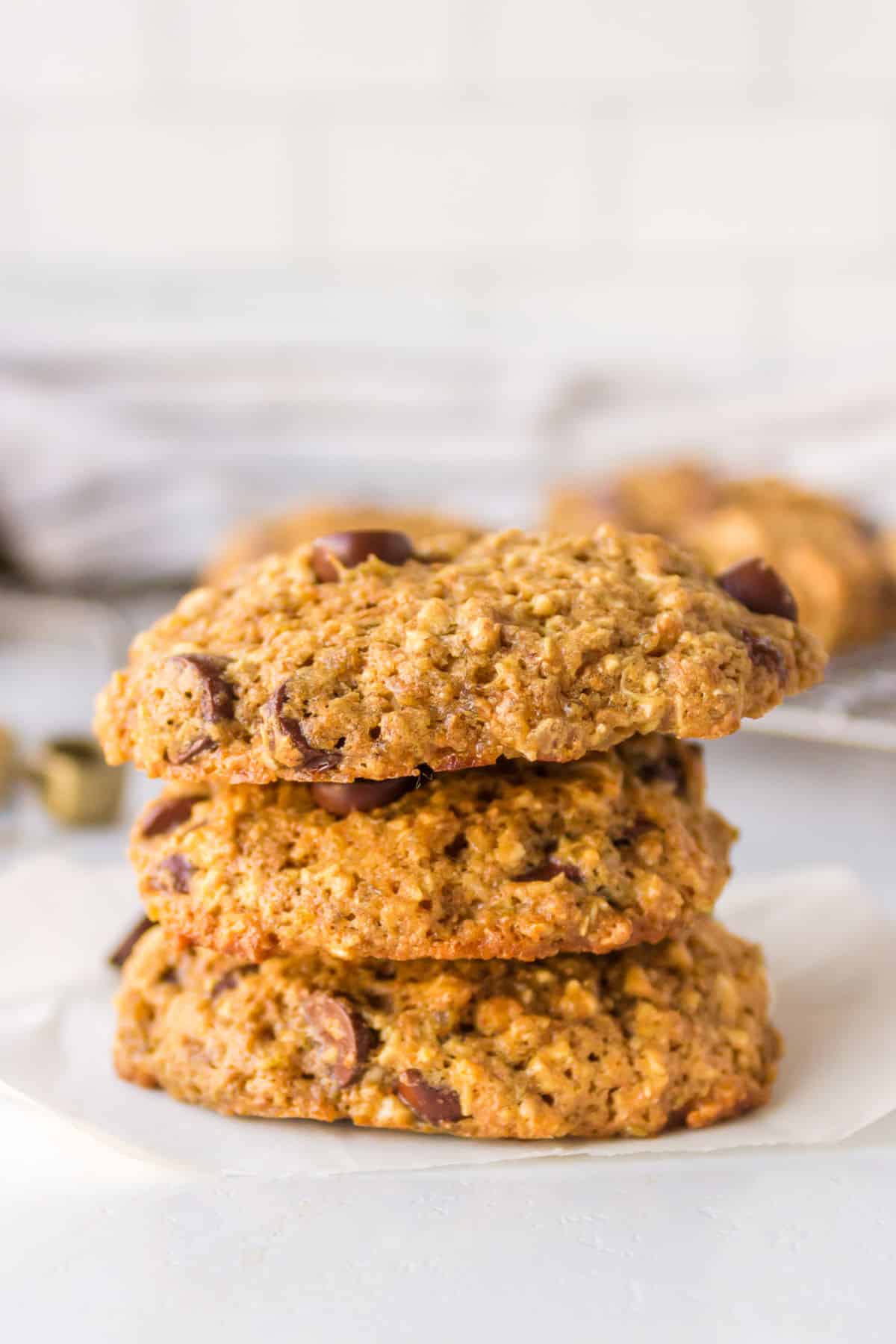 Three quinoa chocolate chunk cookies stacked on top of each other. 