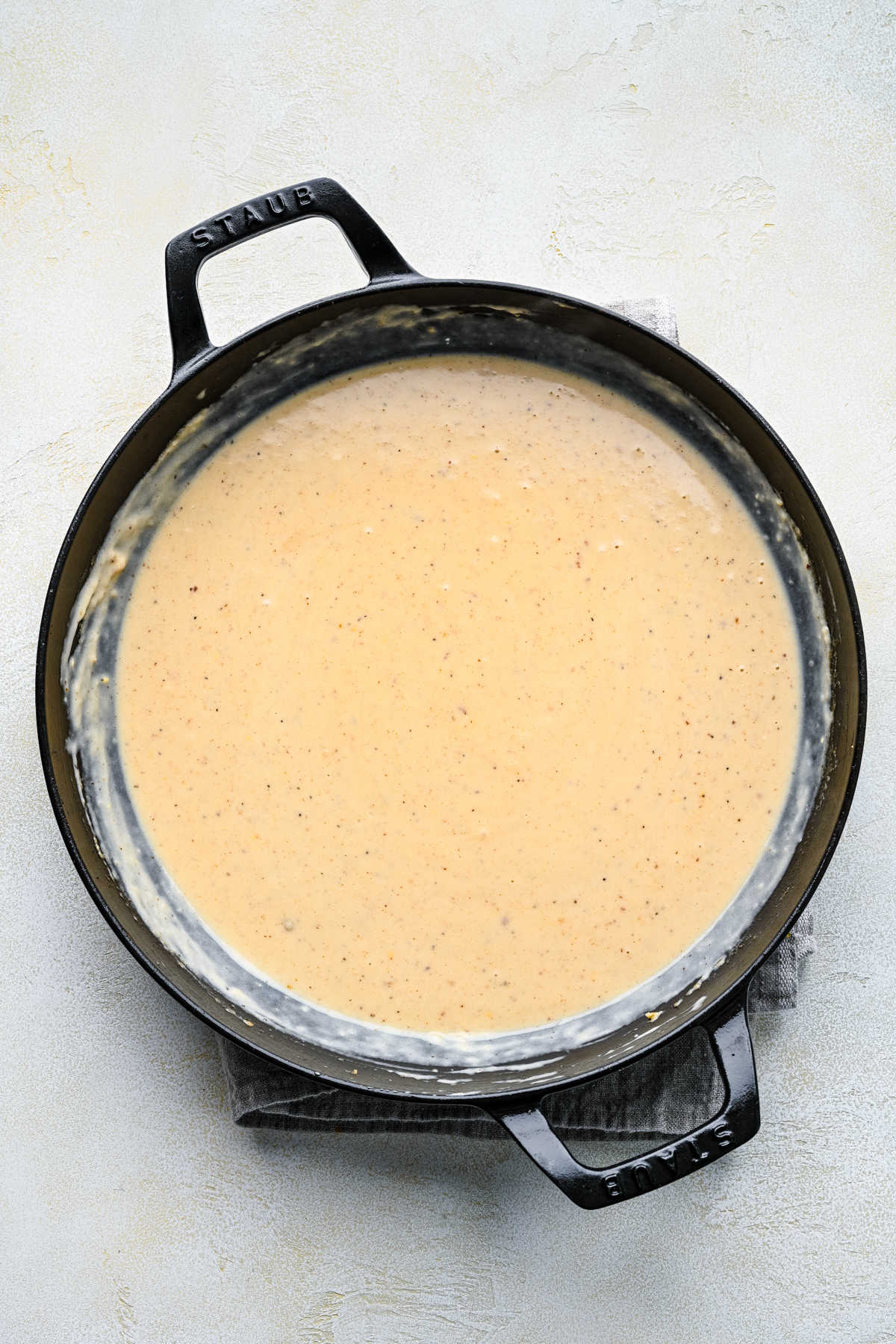 Sour cream stirred in thickened beef and cream mixture.